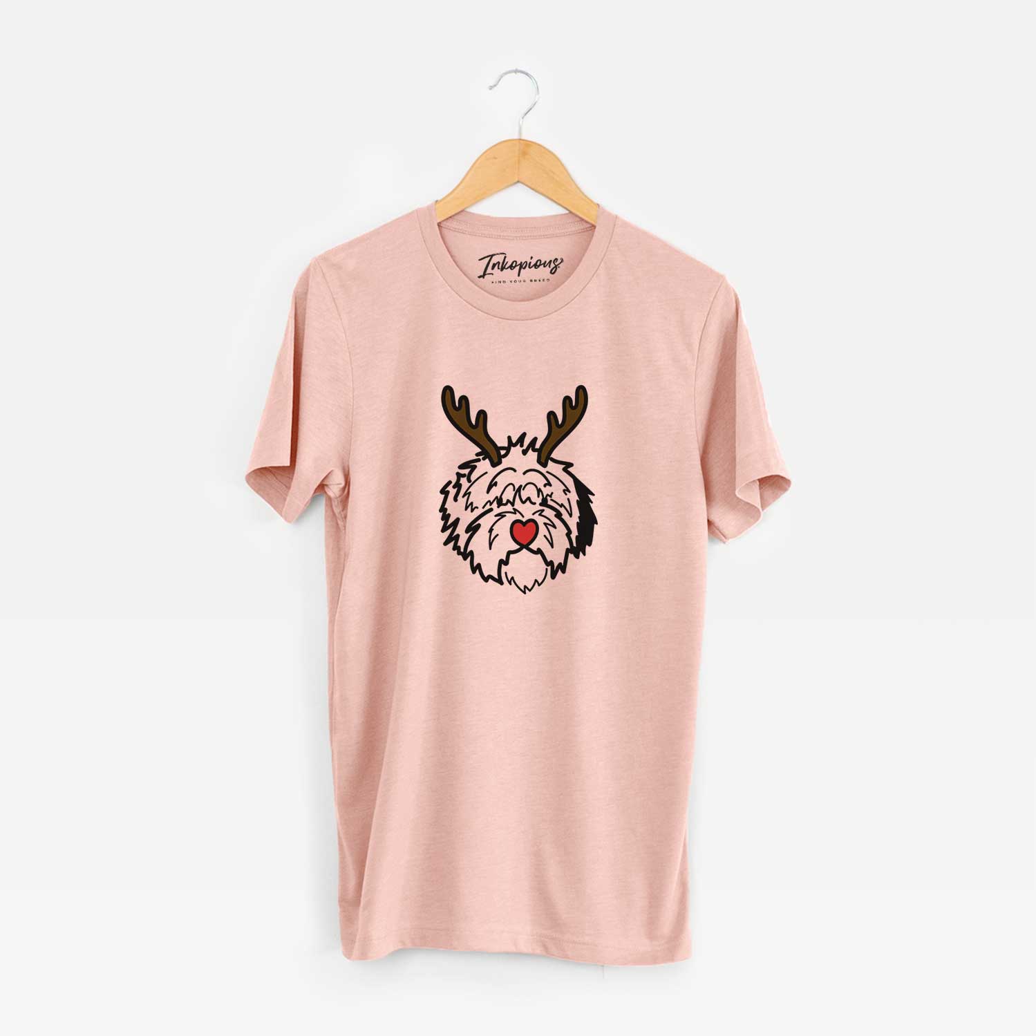 Minimalist line drawing of Penny the Old English Sheepdog with reindeer antlers and a red nose on a Peach Unisex crewneck