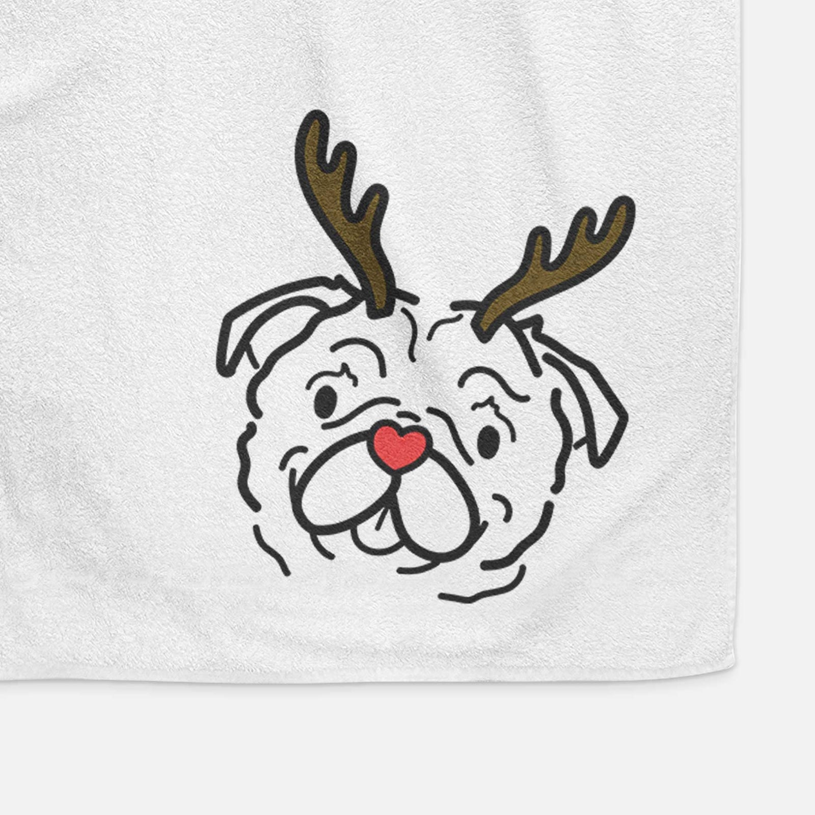 Minimalist line drawing of Pip the Pug with reindeer antlers and a red nose on a decorative hand towel
