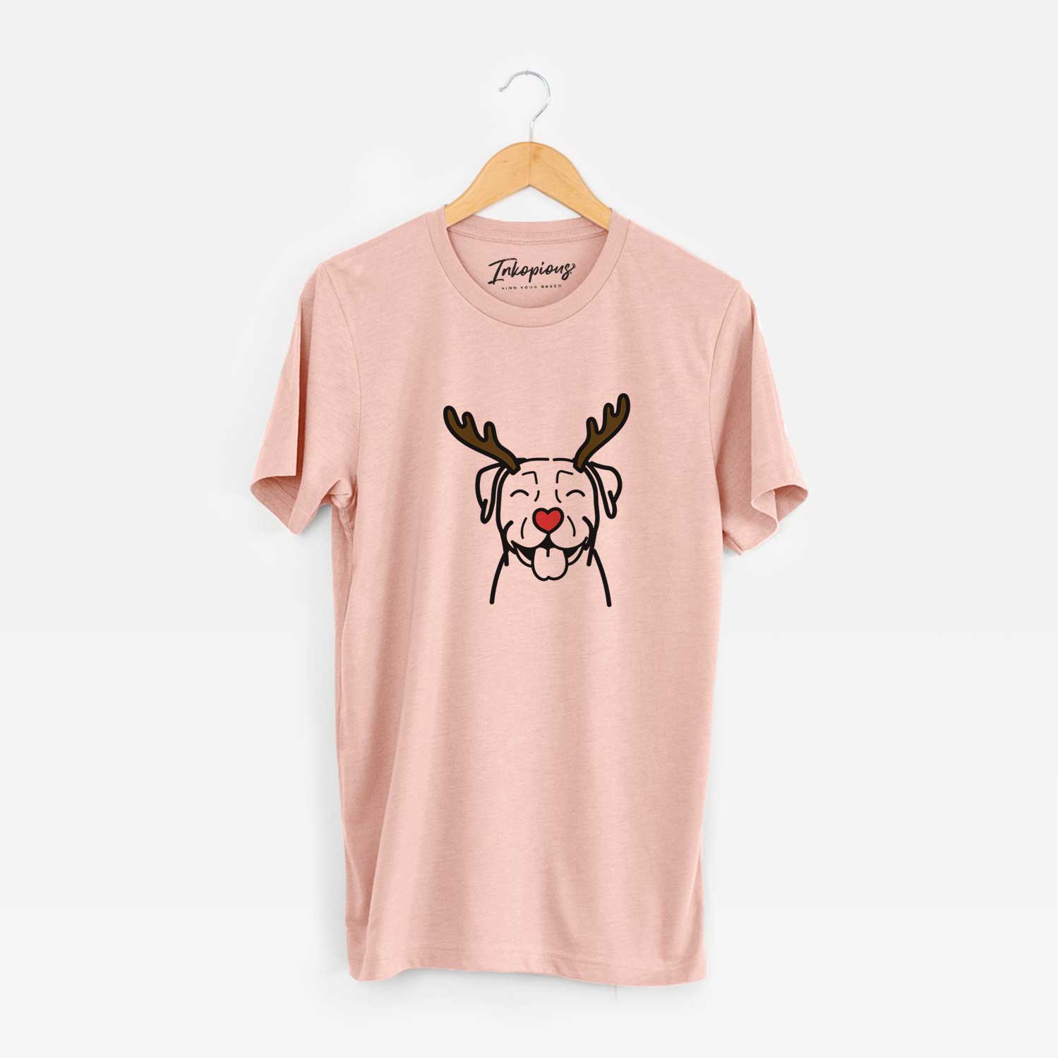 Minimalist line drawing of a Pitbull with reindeer antlers and a red nose on a Peach Unisex crewneck
