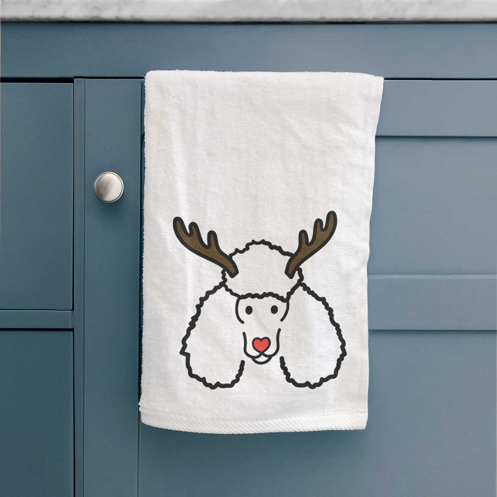 Minimalist line drawing of a Poodle with reindeer antlers and a red nose on a decorative hand towel