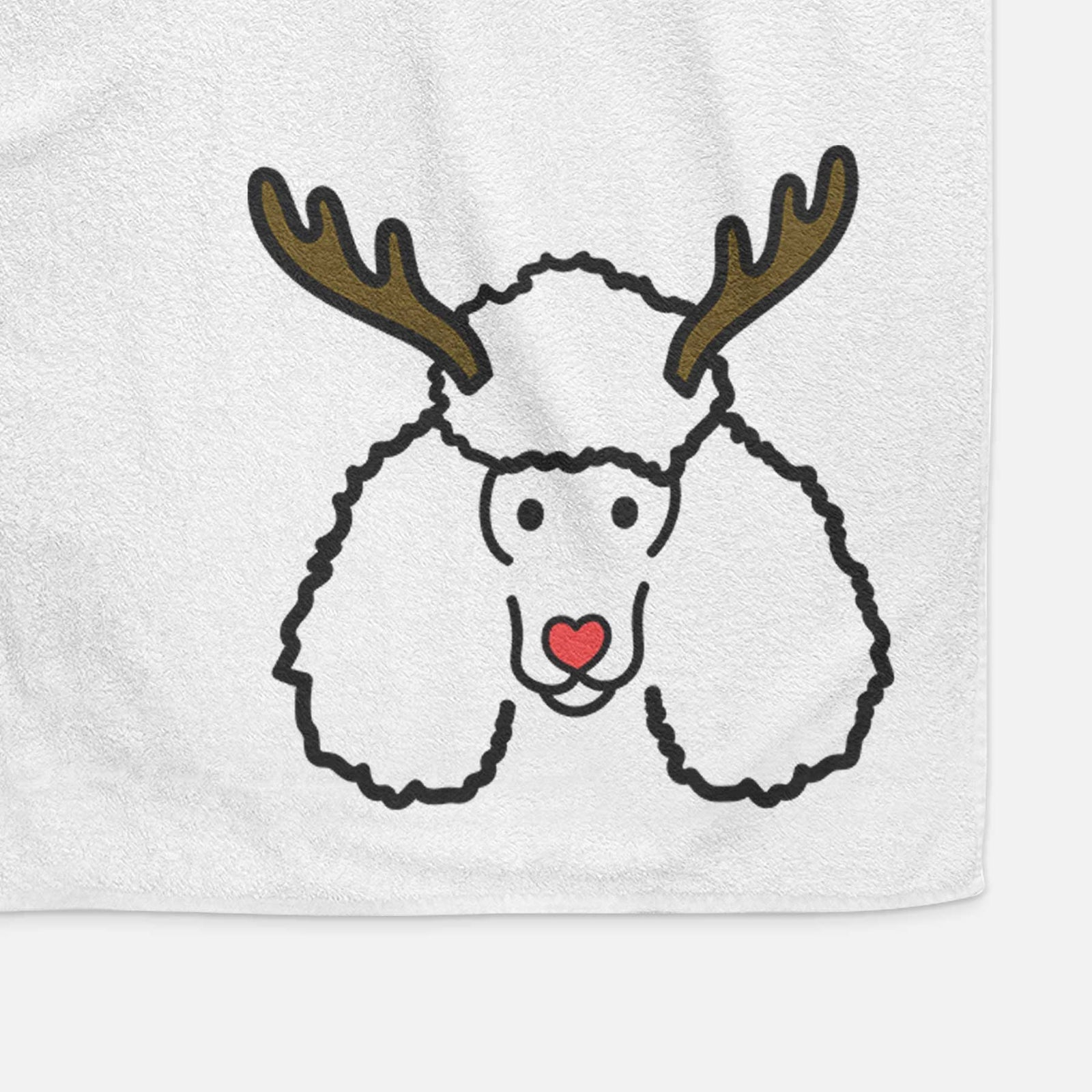 Minimalist line drawing of a Poodle with reindeer antlers and a red nose on a decorative hand towel