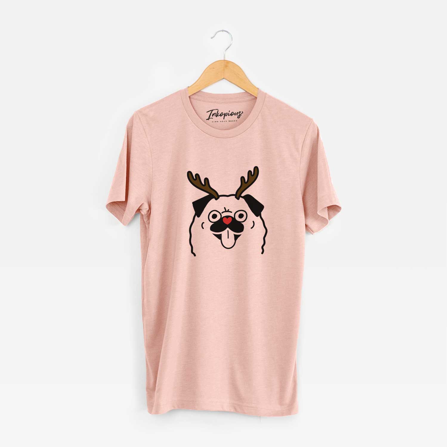 Minimalist line drawing of a Pug with reindeer antlers and a red nose on a Peach Unisex crewneck