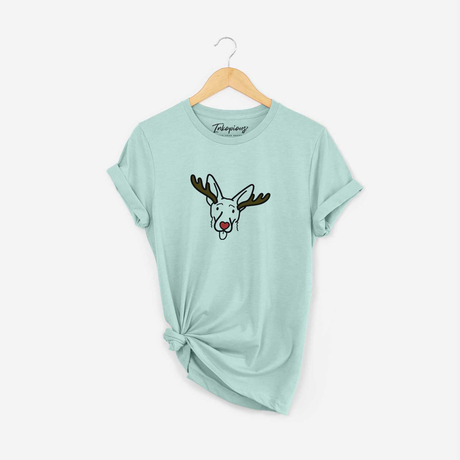 Minimalist line drawing of Rosie the Shepherd Mix with reindeer antlers and a red nose on a Heather Sage Unisex crewneck