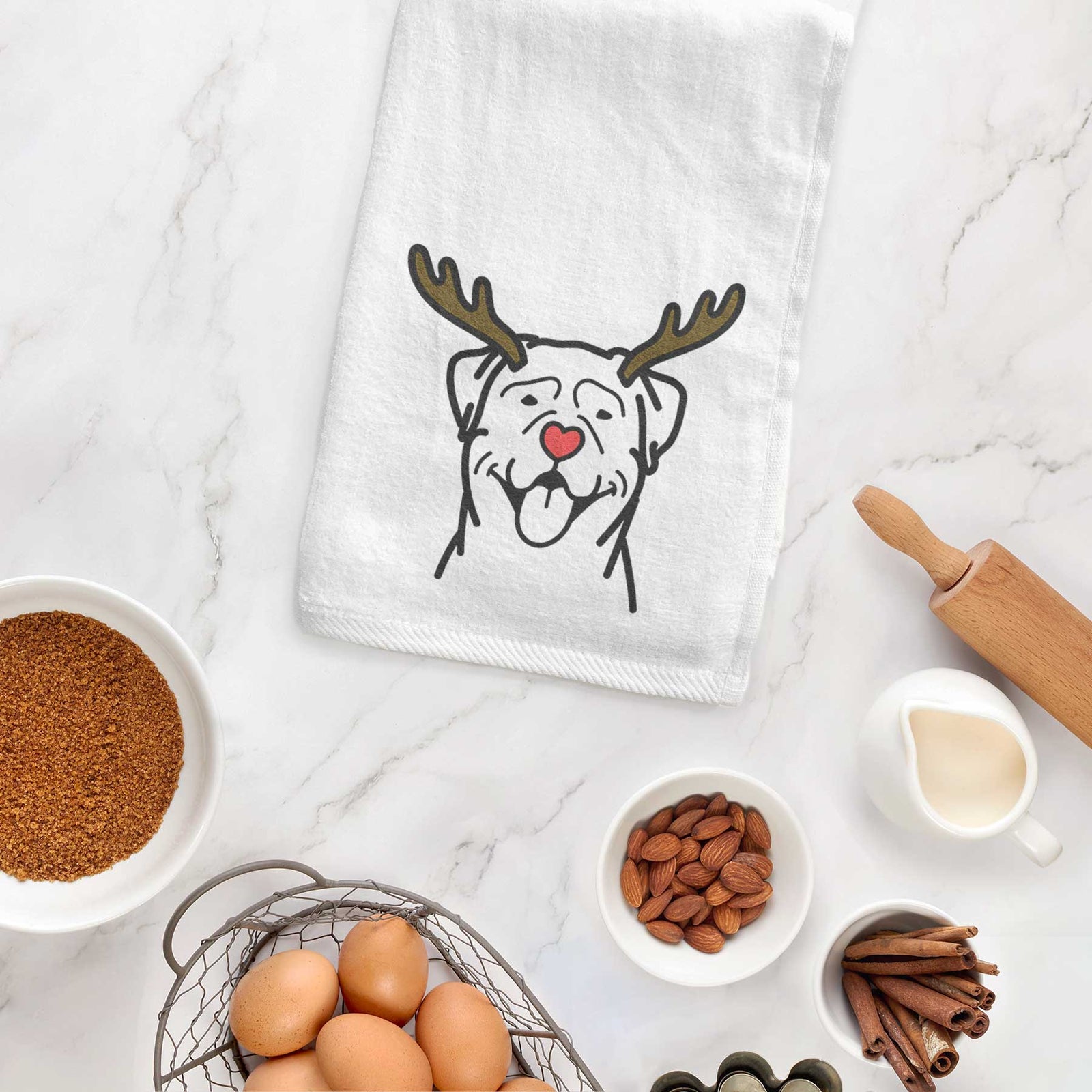 Minimalist line drawing of a Rottweiler with reindeer antlers and a red nose on a decorative hand towel