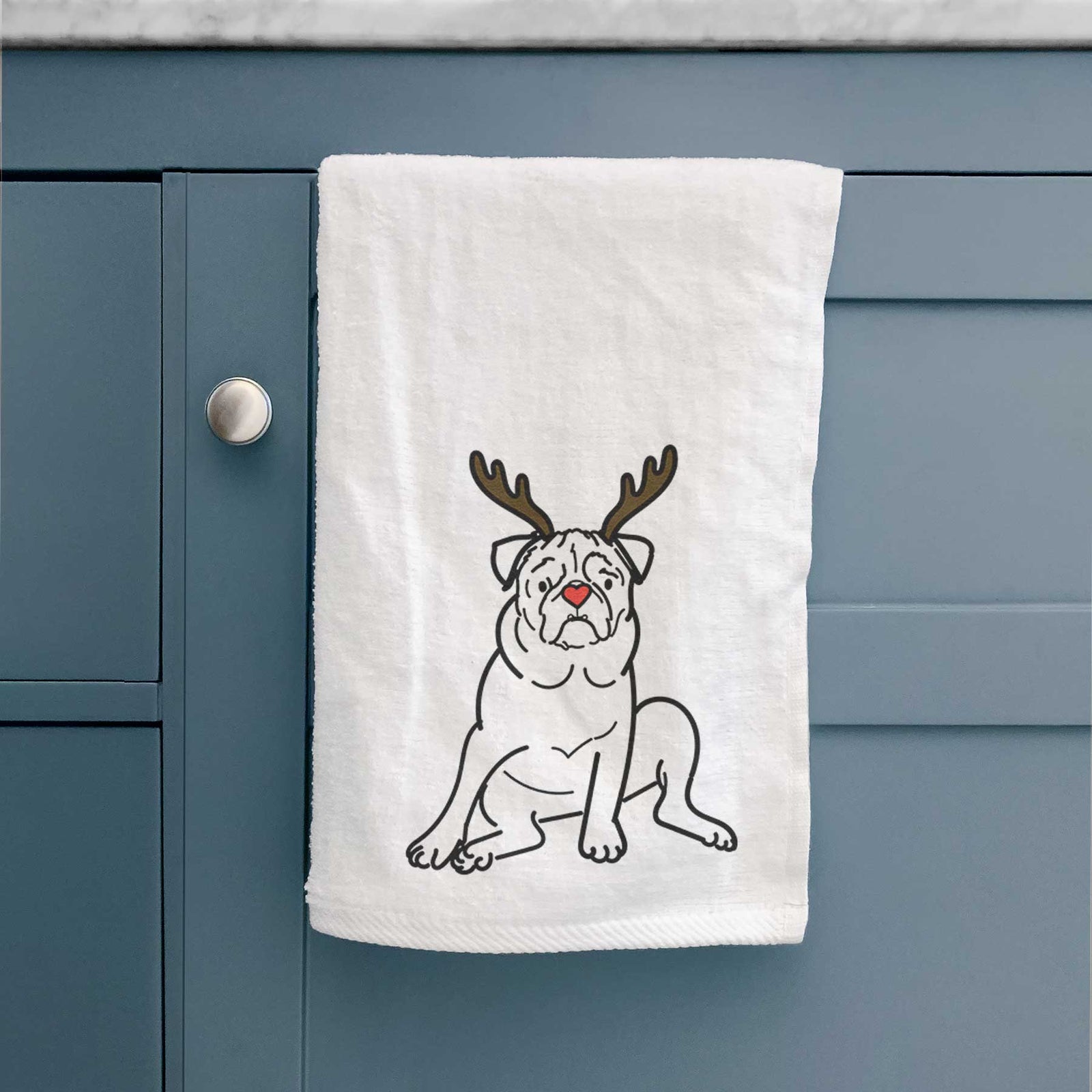 Minimalist line drawing of Rudy the Pug with reindeer antlers and a red nose on a decorative hand towel