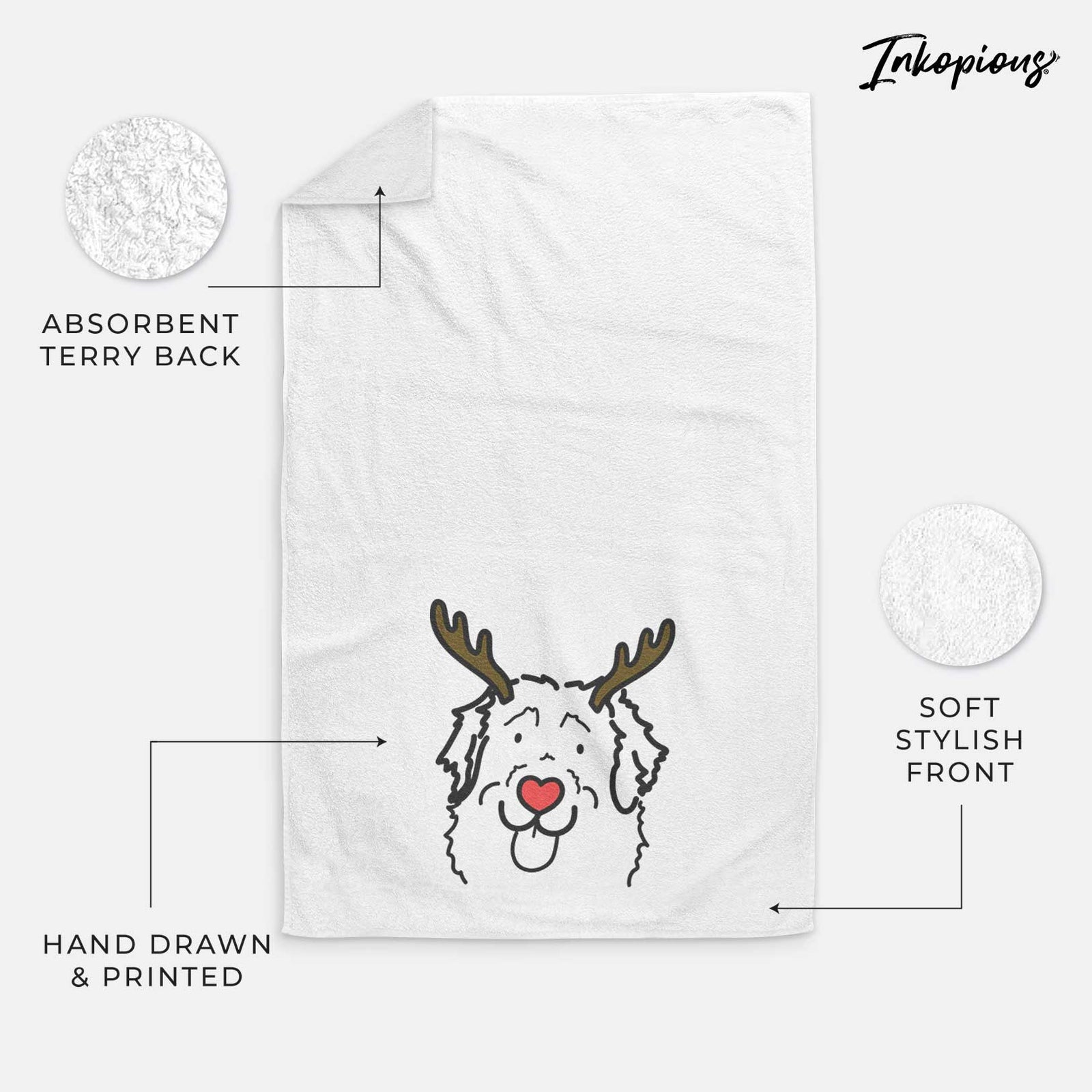 Minimalist line drawing of Sabre the Leonberger with reindeer antlers and a red nose on a decorative hand towel
