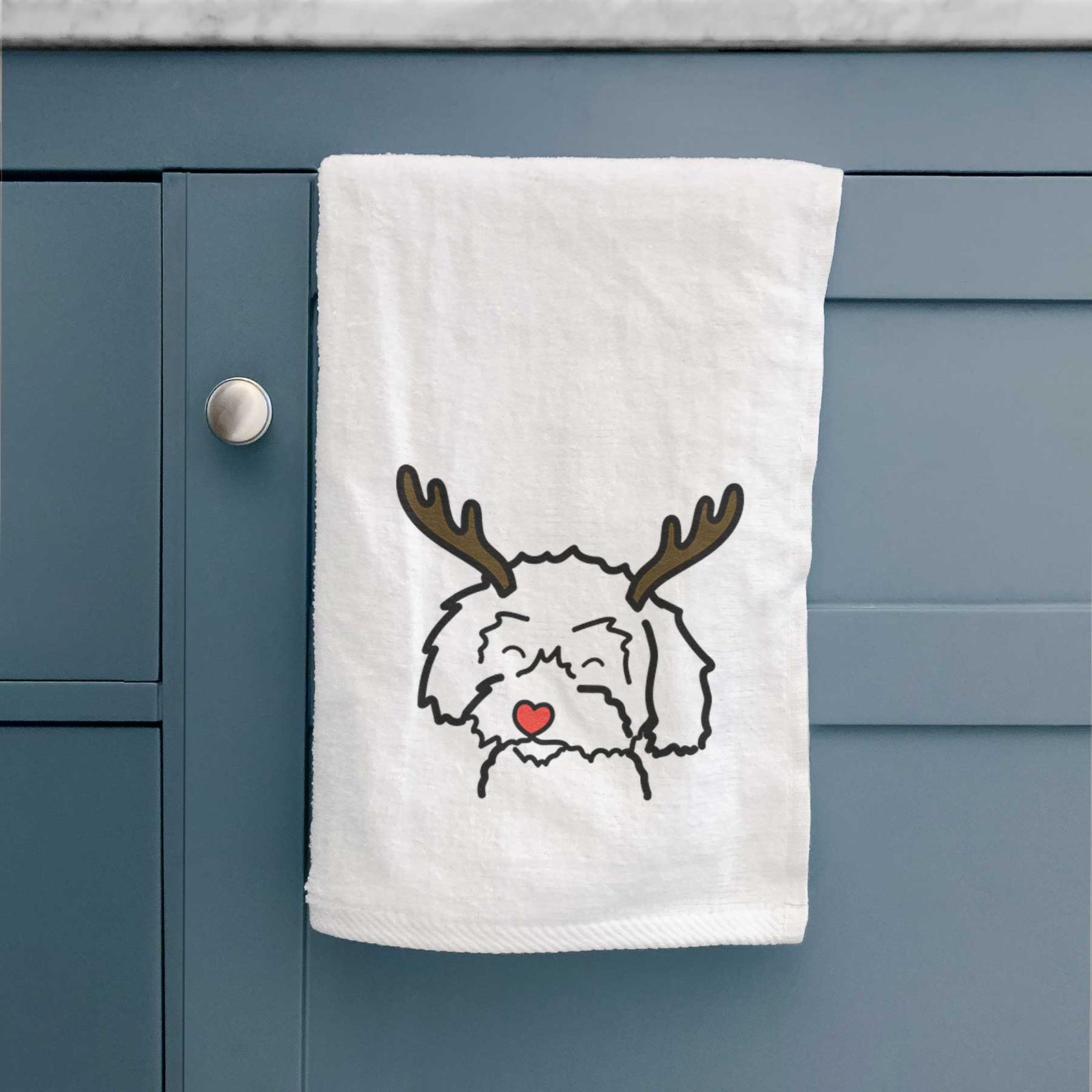Minimalist line drawing of a Schnoodle with reindeer antlers and a red nose on a decorative hand towel