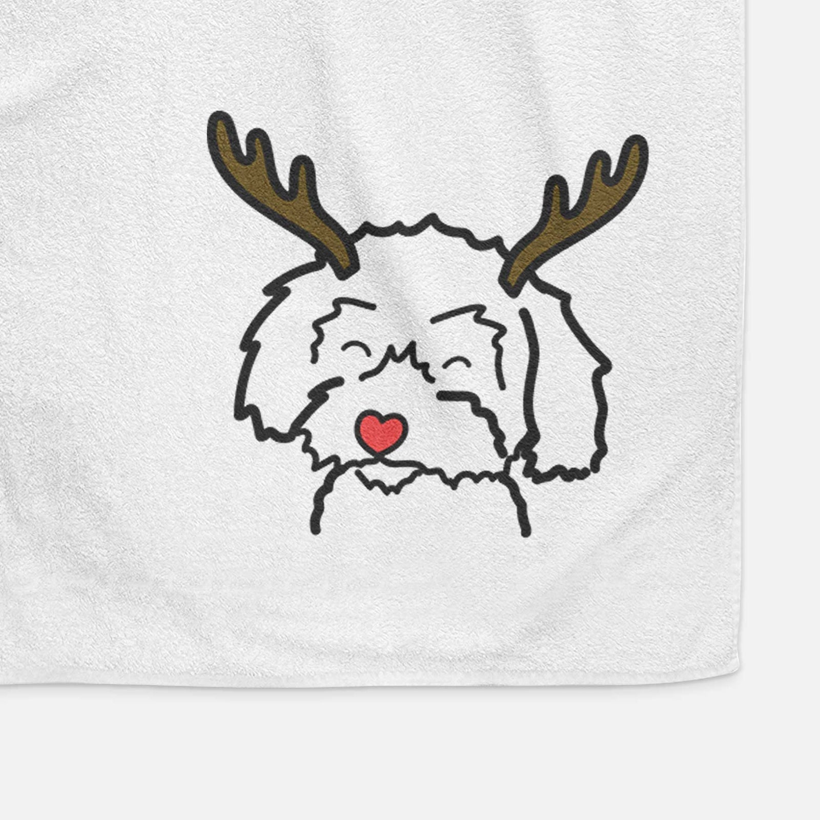 Minimalist line drawing of a Schnoodle with reindeer antlers and a red nose on a decorative hand towel