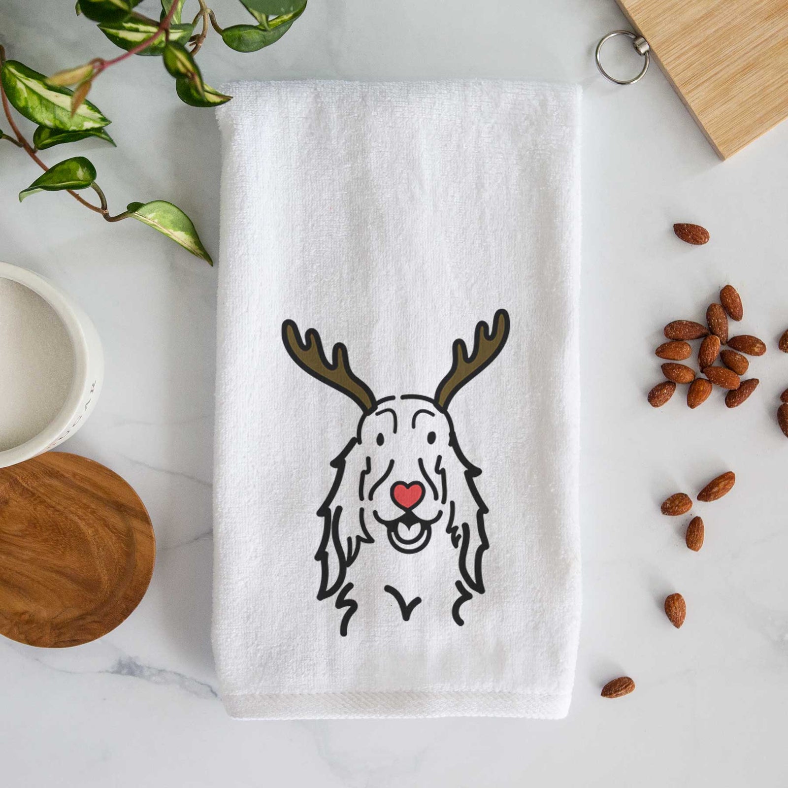 Minimalist line drawing of a Setter with reindeer antlers and a red nose on a decorative hand towel
