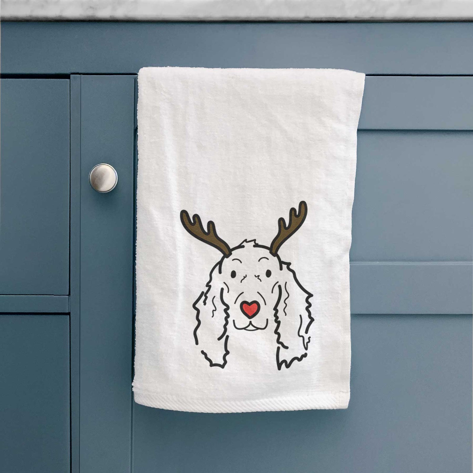 Minimalist line drawing of Seven the Irish Setter with reindeer antlers and a red nose on a decorative hand towel