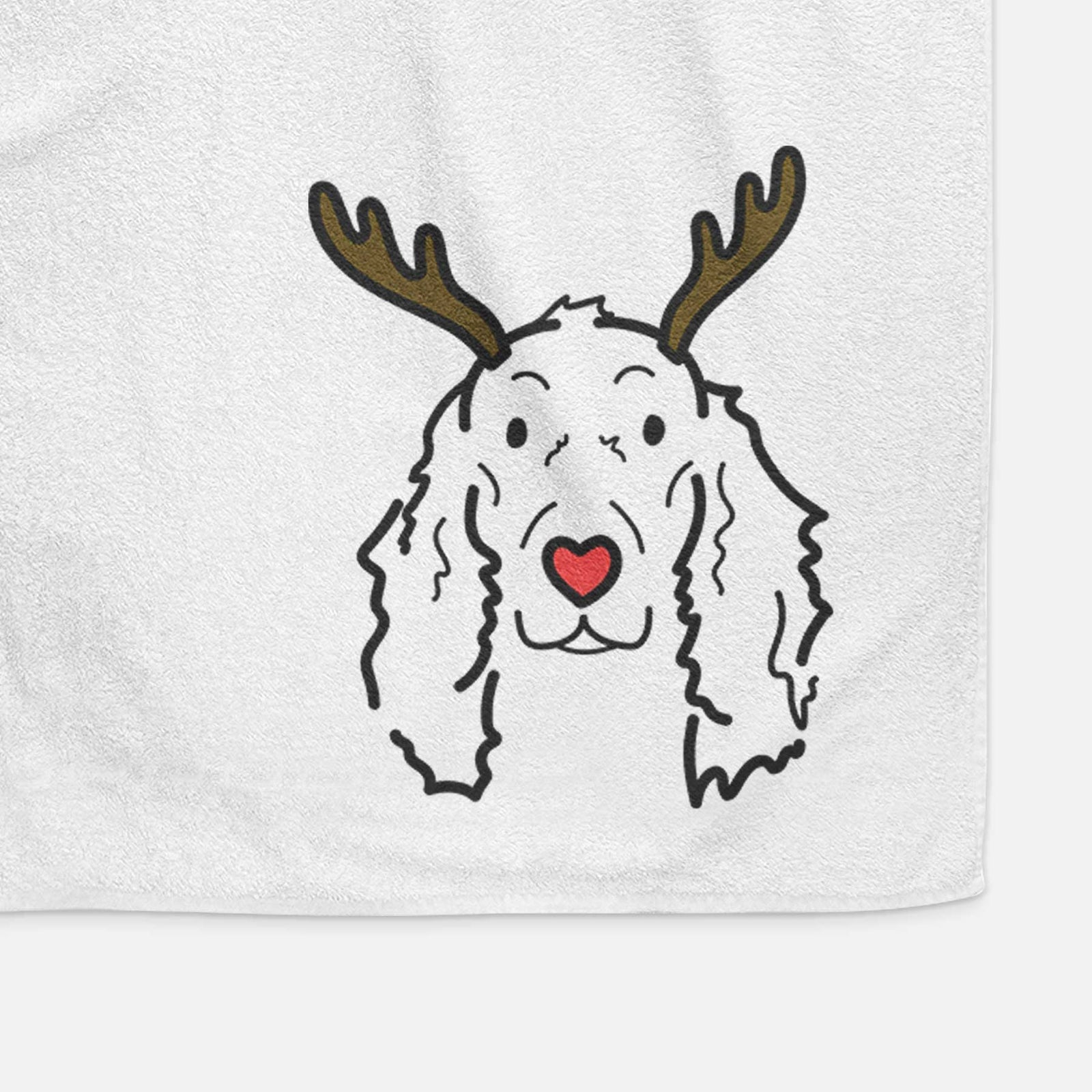 Minimalist line drawing of Seven the Irish Setter with reindeer antlers and a red nose on a decorative hand towel