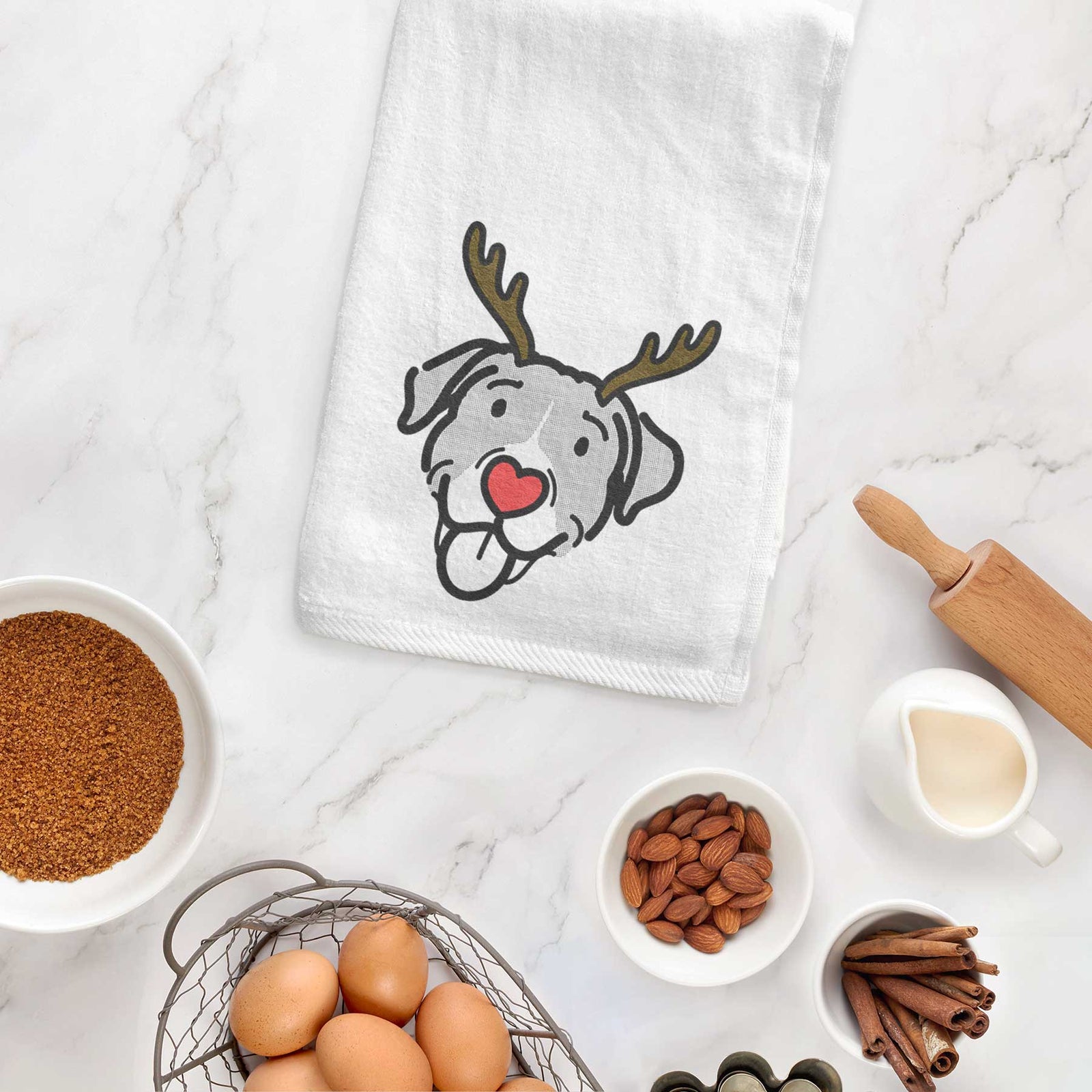 Minimalist line drawing of Shadow the Pitbull Mix with reindeer antlers and a red nose on a decorative hand towel