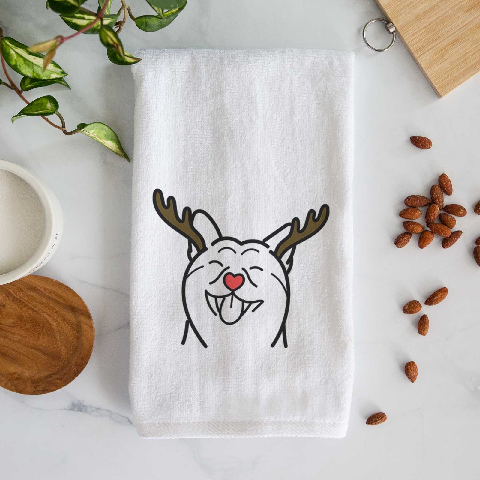 Minimalist line drawing of a Shiba Inu with reindeer antlers and a red nose on a decorative hand towel