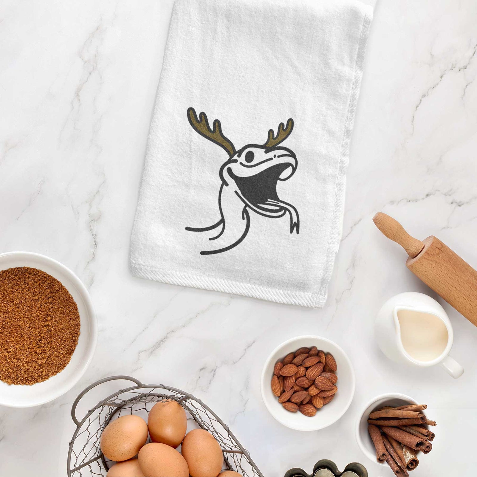 Minimalist line drawing of Spike the Snake with reindeer antlers and a red nose on a decorative hand towel