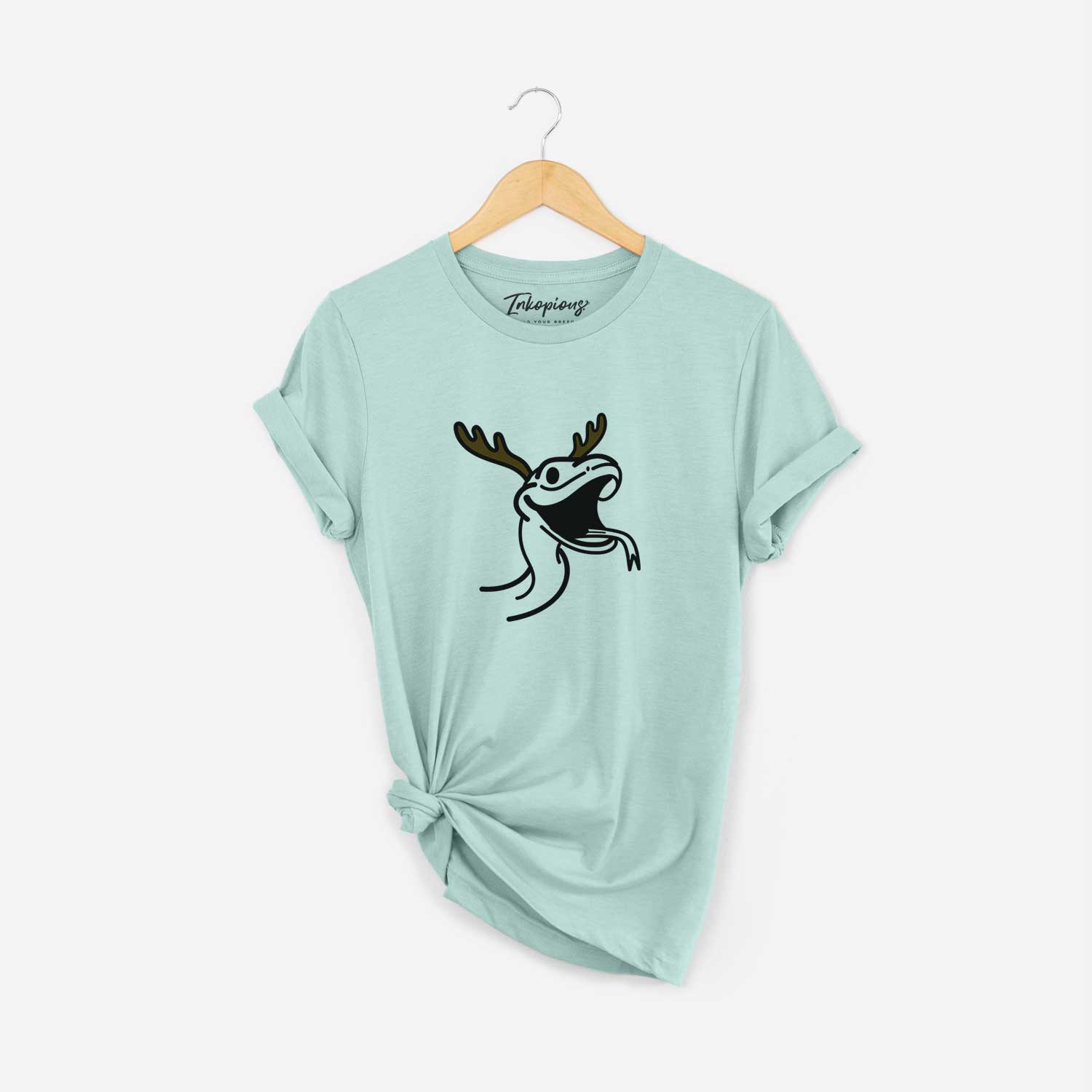 Minimalist line drawing of Spike the Snake with reindeer antlers and a red nose on a Heather Sage Unisex crewneck