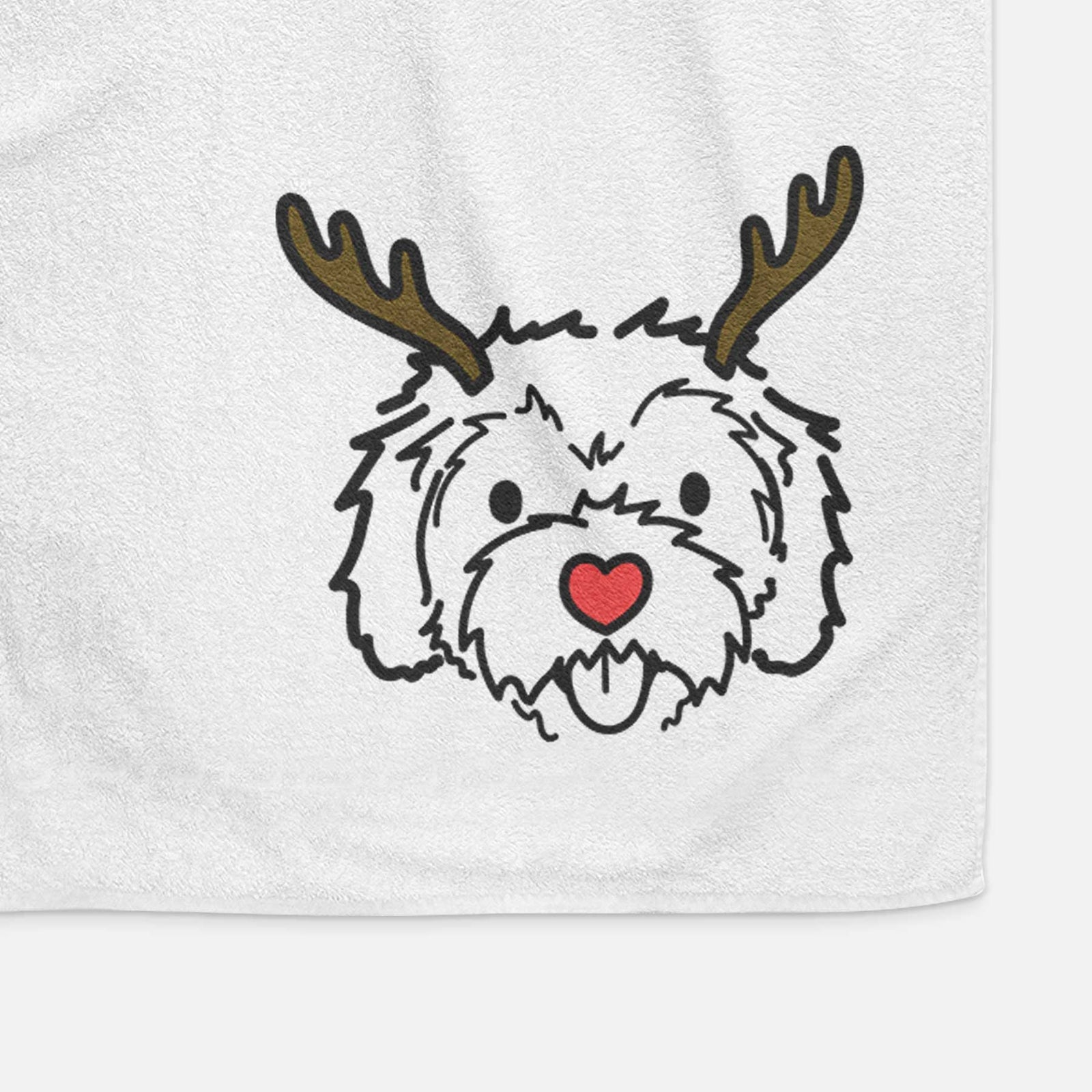 Minimalist line drawing of Sprinkles the Cockapoo with reindeer antlers and a red nose on a decorative hand towel