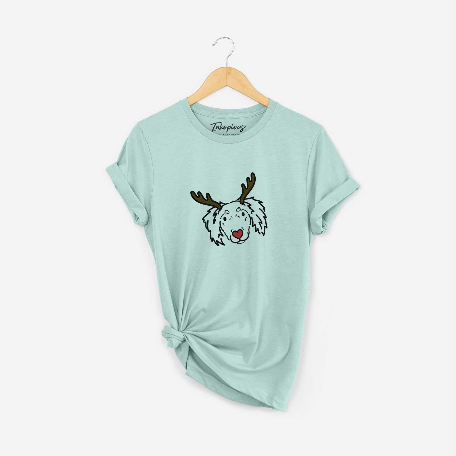 Minimalist line drawing of Tilly the Dachshund Mix with reindeer antlers and a red nose on a Heather Sage Unisex crewneck