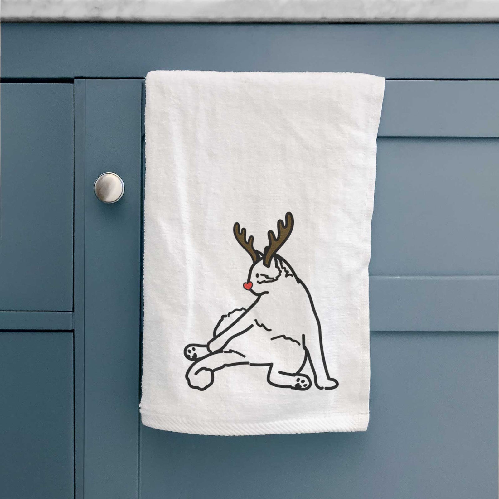 Minimalist line drawing of Tom the Cat with reindeer antlers and a red nose on a decorative hand towel