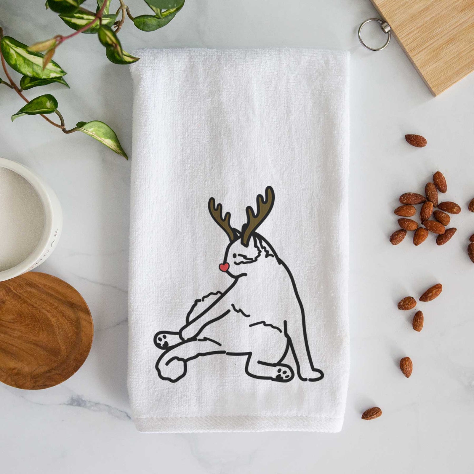 Minimalist line drawing of Tom the Cat with reindeer antlers and a red nose on a decorative hand towel