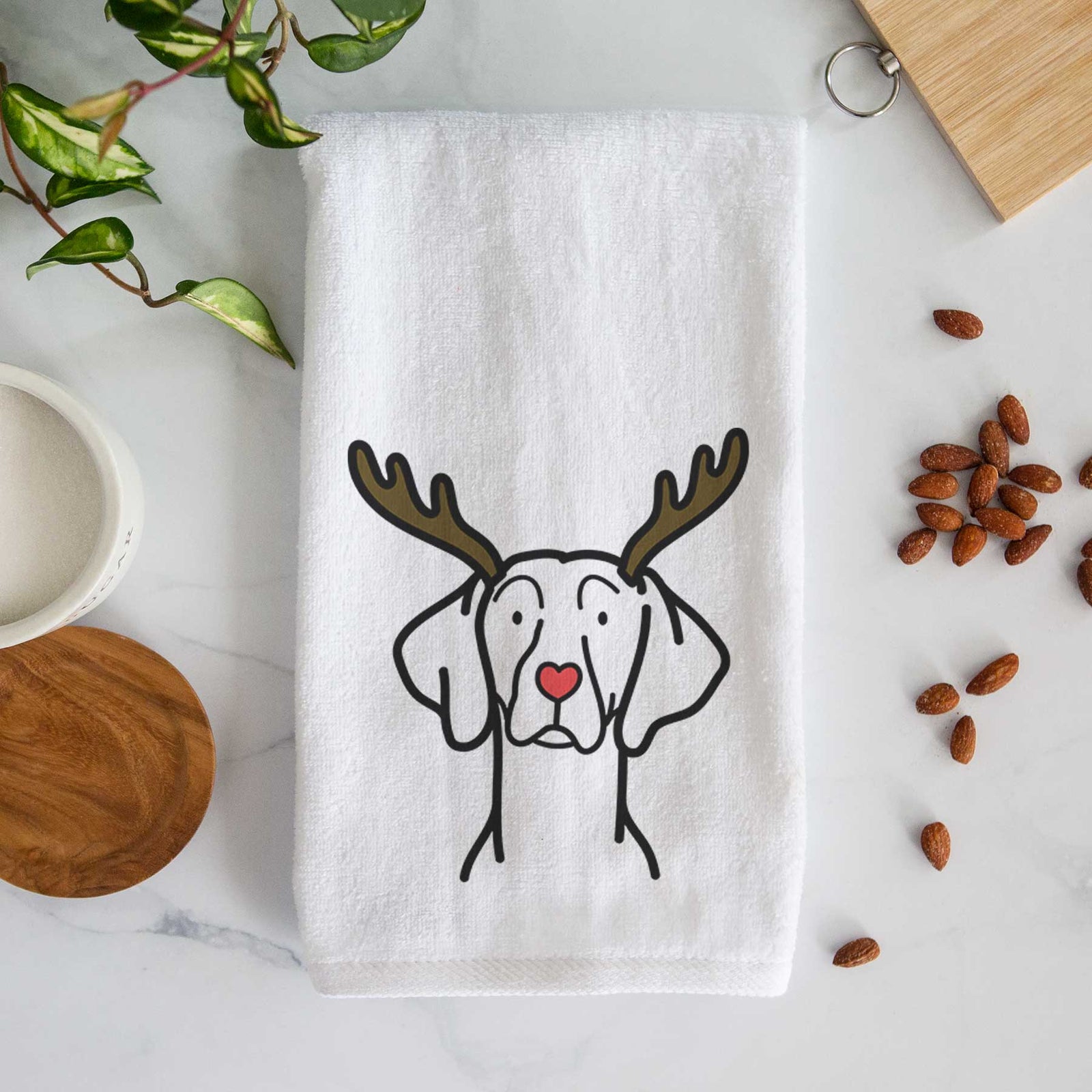 Minimalist line drawing of a Weimaraner with reindeer antlers and a red nose on a decorative hand towel