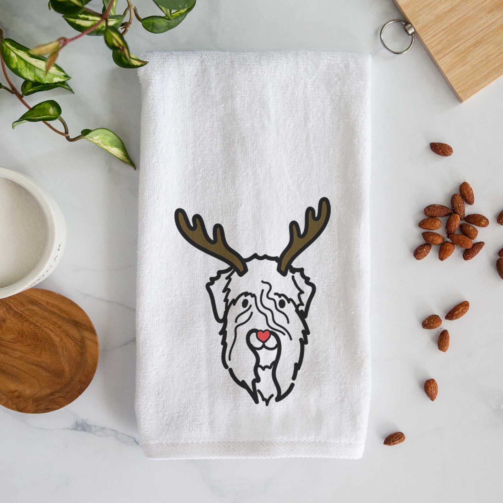 Minimalist line drawing of a Soft Coated Wheaten Terrier with reindeer antlers and a red nose on a decorative hand towel