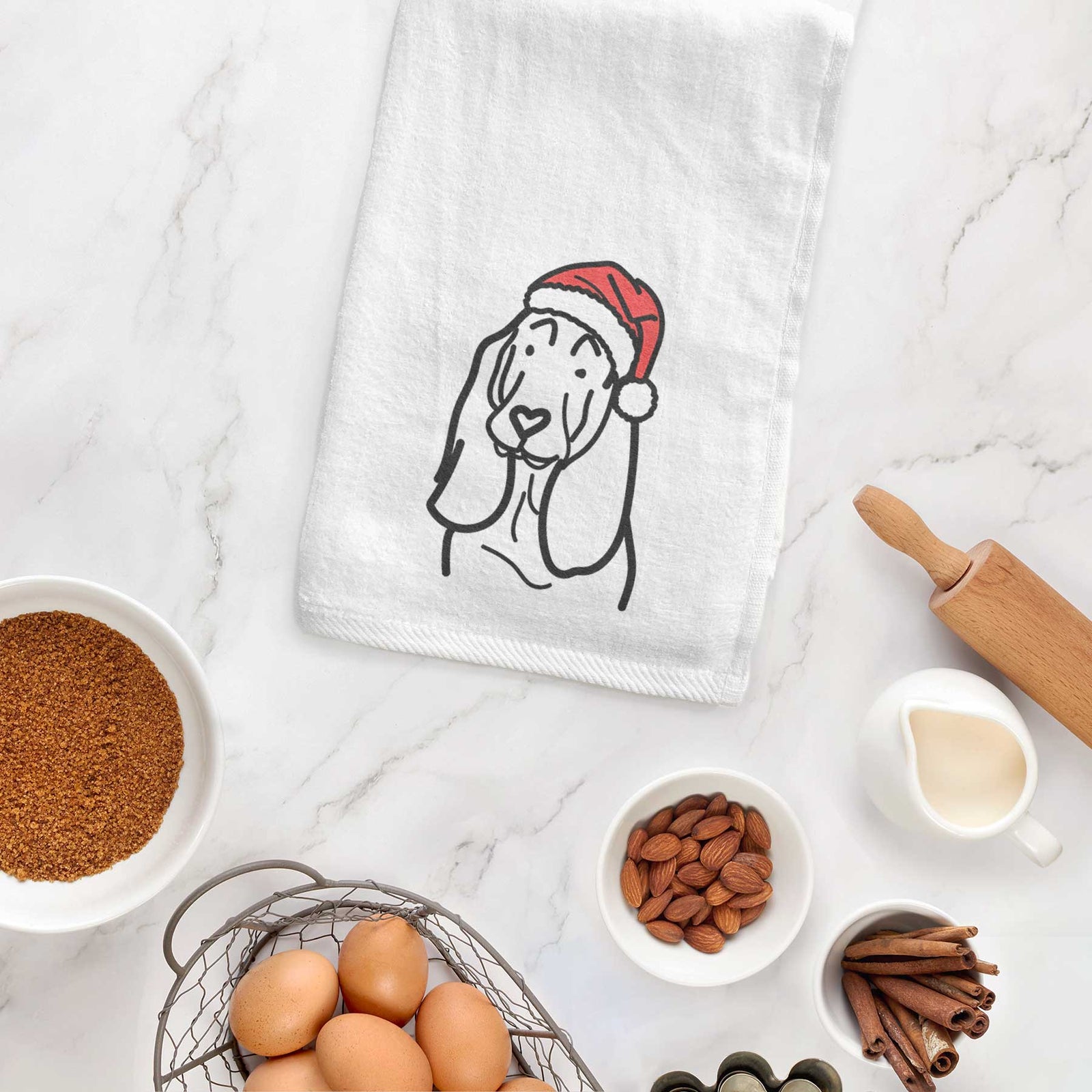 Minimalist line drawing of a Basset Hound wearing a Santa hat on a decorative hand towel