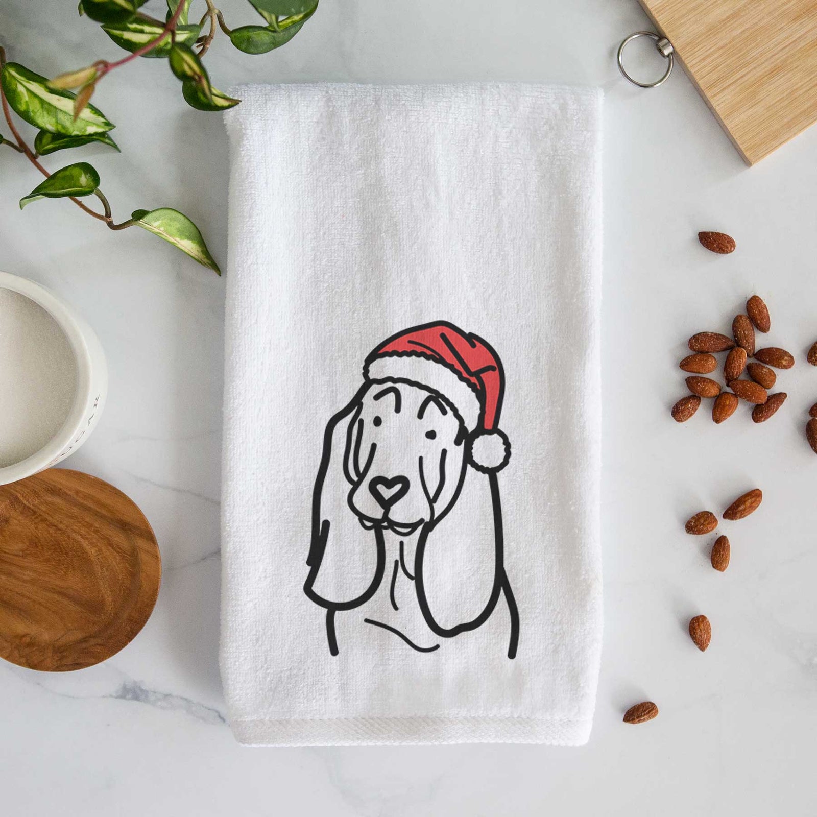 Minimalist line drawing of a Basset Hound wearing a Santa hat on a decorative hand towel
