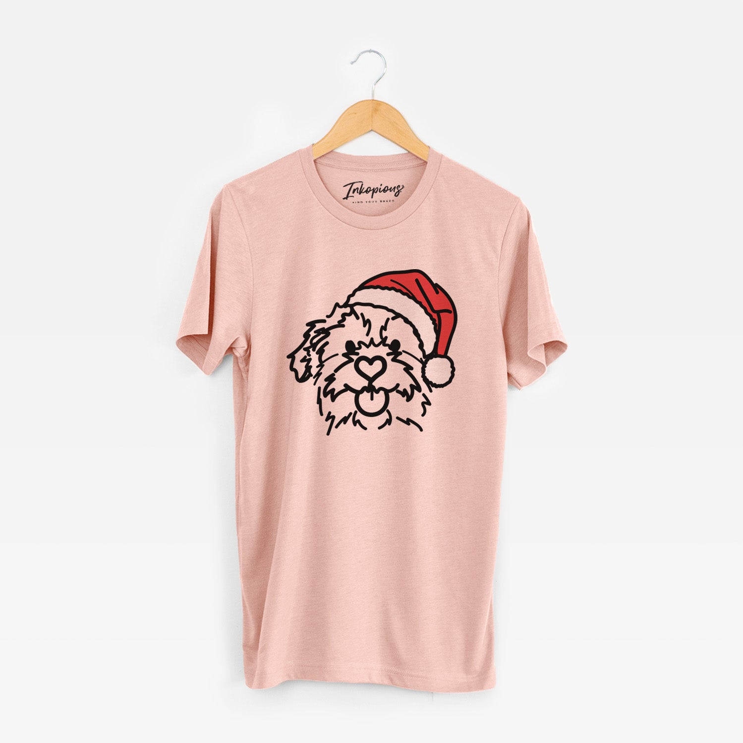 Minimalist line drawing of Bea the Mixed Breed wearing a Santa hat on a Peach Unisex crewneck
