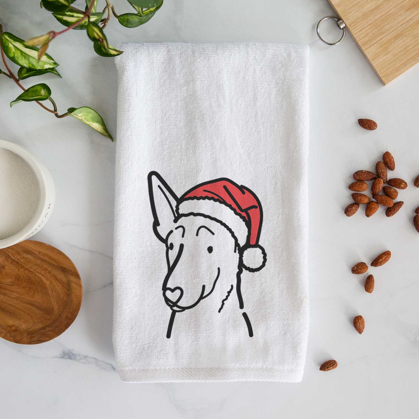 Minimalist line drawing of a Belgian Malinois wearing a Santa hat on a decorative hand towel