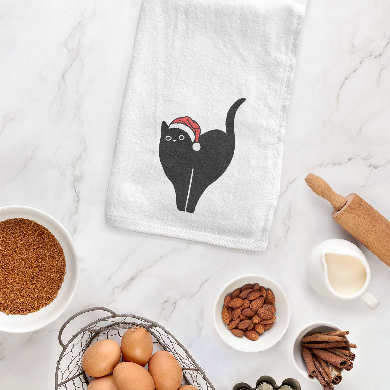 Minimalist line drawing of Bella the Black Cat wearing a Santa hat on a decorative hand towel
