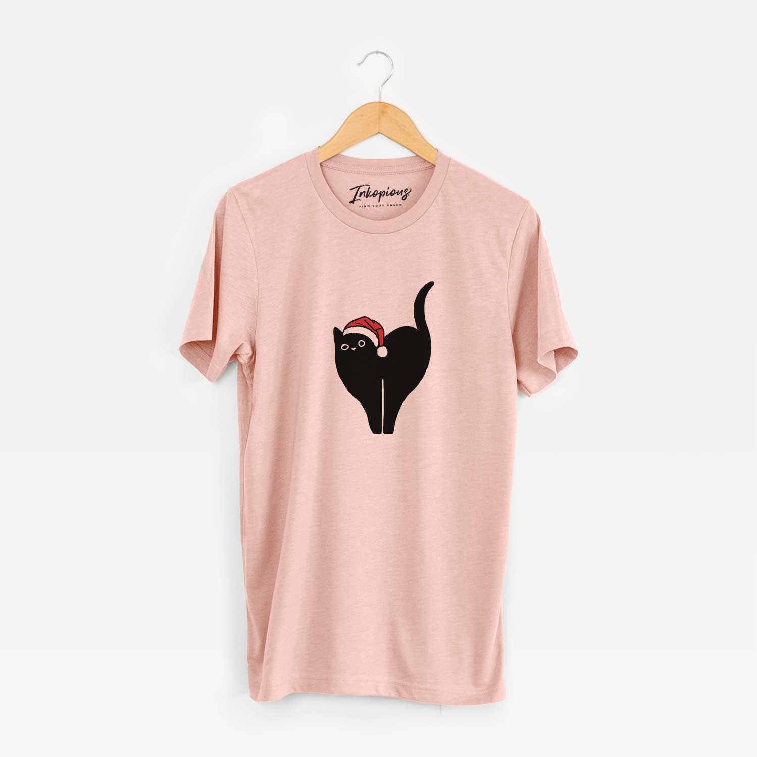 Minimalist line drawing of Bella the Black Cat wearing a Santa hat on a Peach Unisex crewneck