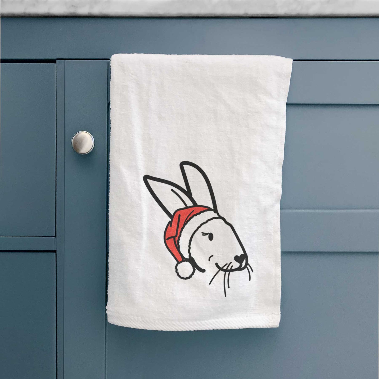 Minimalist line drawing of Betsy the Rex Rabbit wearing a Santa hat on a decorative hand towel