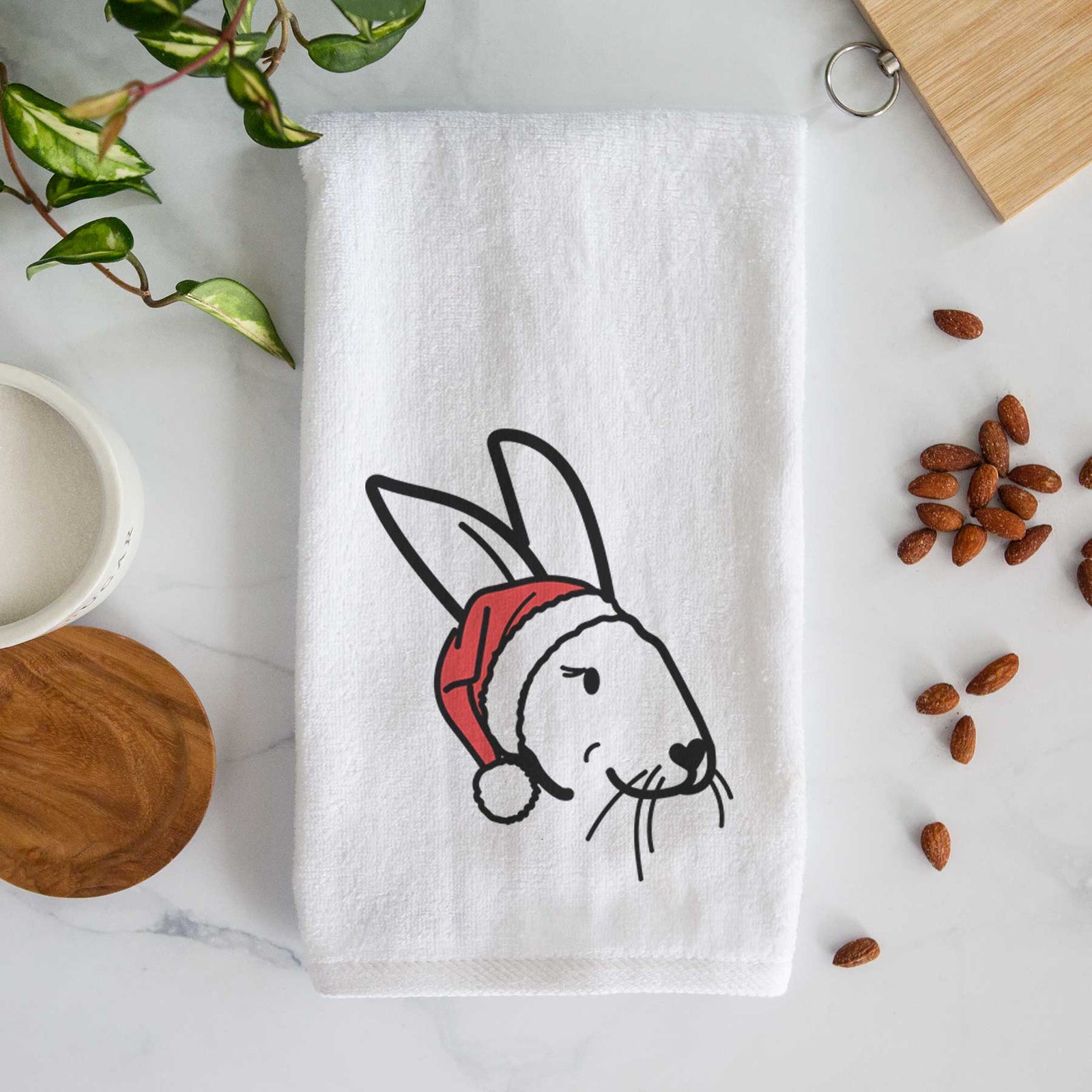 Minimalist line drawing of Betsy the Rex Rabbit wearing a Santa hat on a decorative hand towel