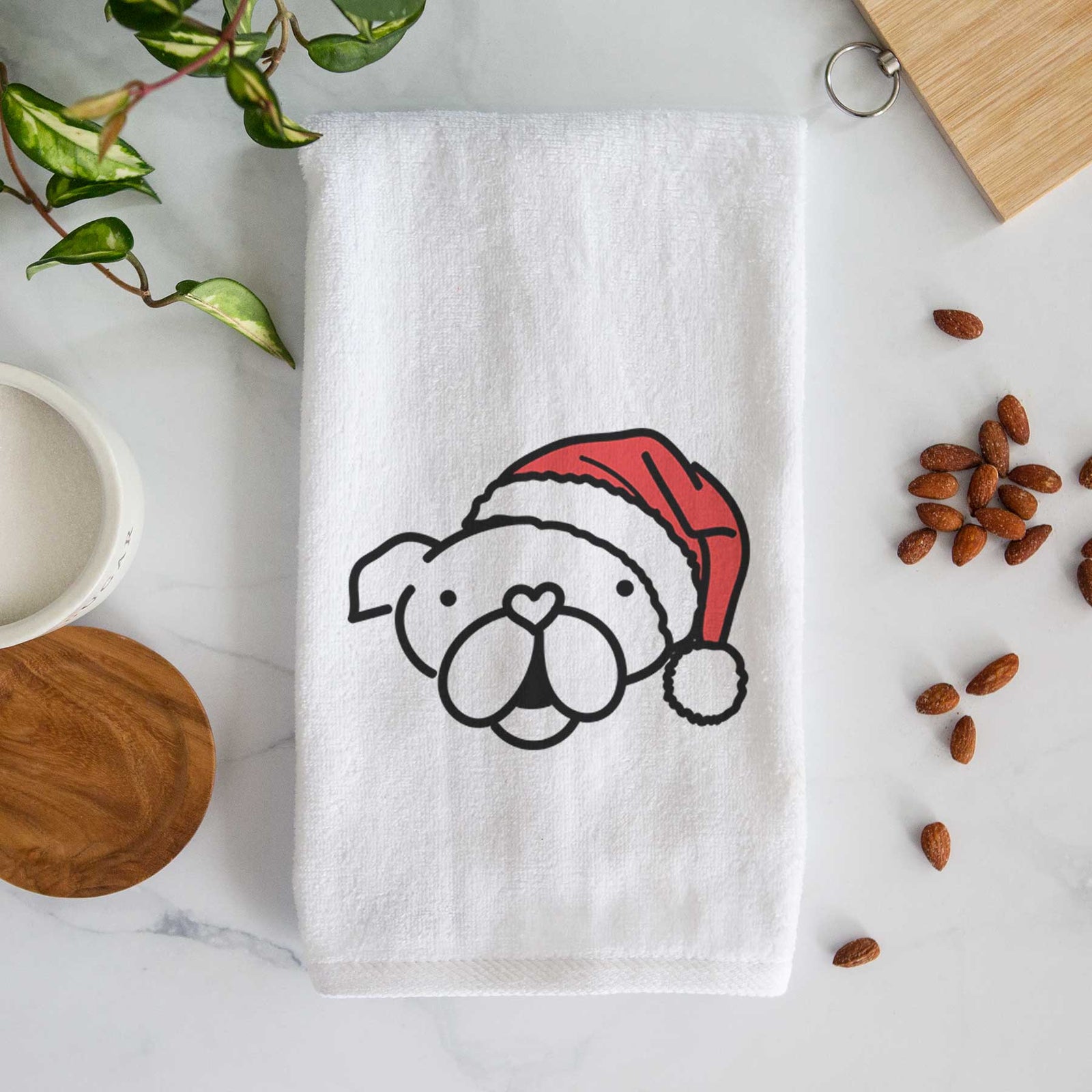 Minimalist line drawing of an English Bulldog wearing a Santa hat on a decorative hand towel