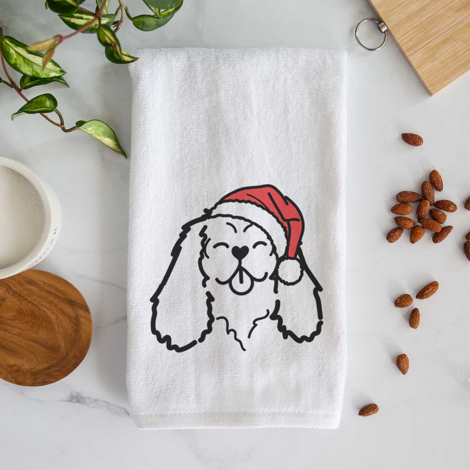 Minimalist line drawing of a Cavalier King Charles Spaniel wearing a Santa hat on a decorative hand towel