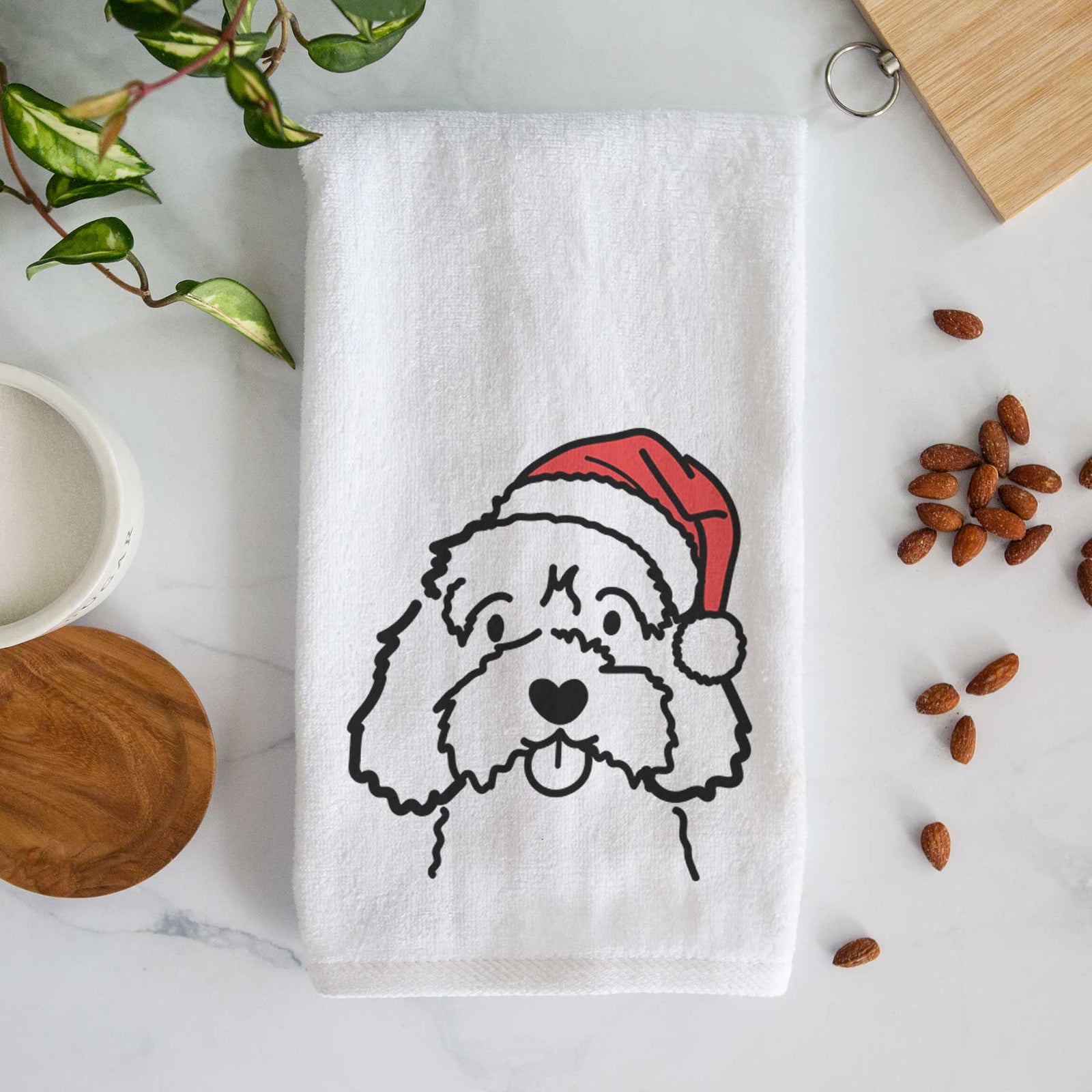 Minimalist line drawing of a Cavapoo wearing a Santa hat on a decorative hand towel