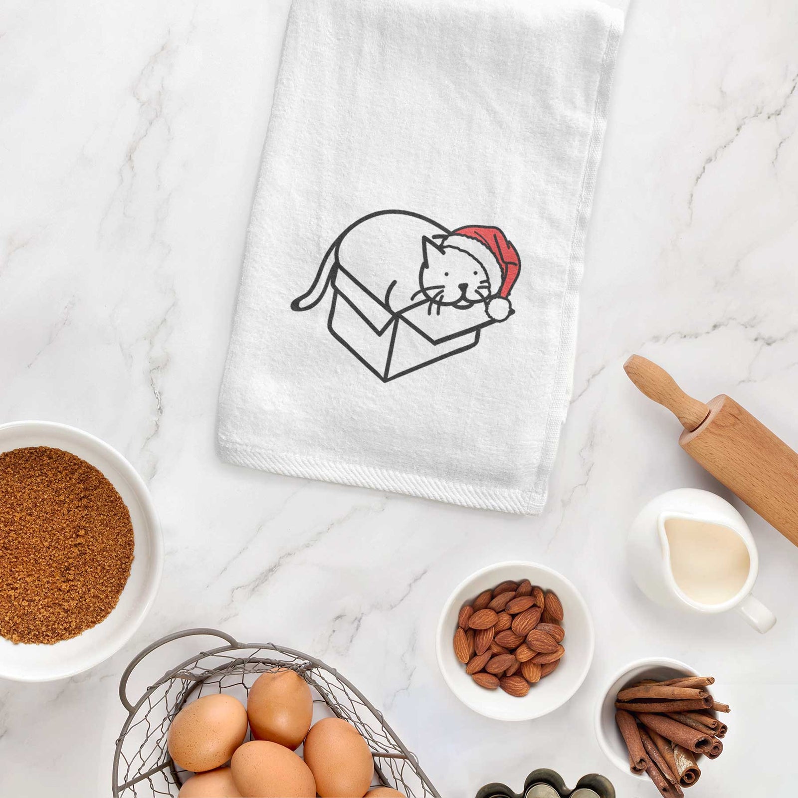 Minimalist line drawing of Charlie the Cat in a Box wearing a Santa hat on a decorative hand towel