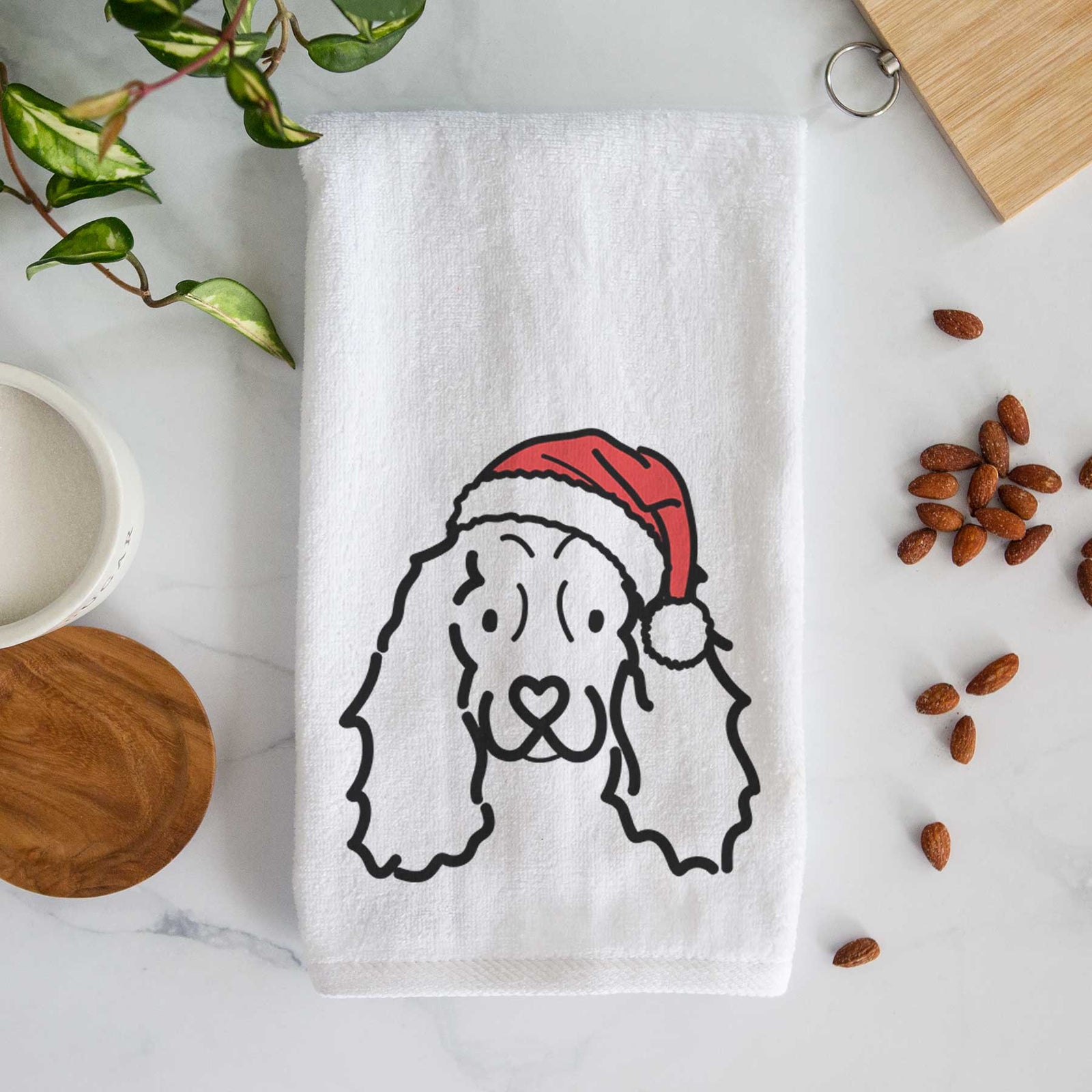 Minimalist line drawing of an American Cocker Spaniel wearing a Santa hat on a decorative hand towel