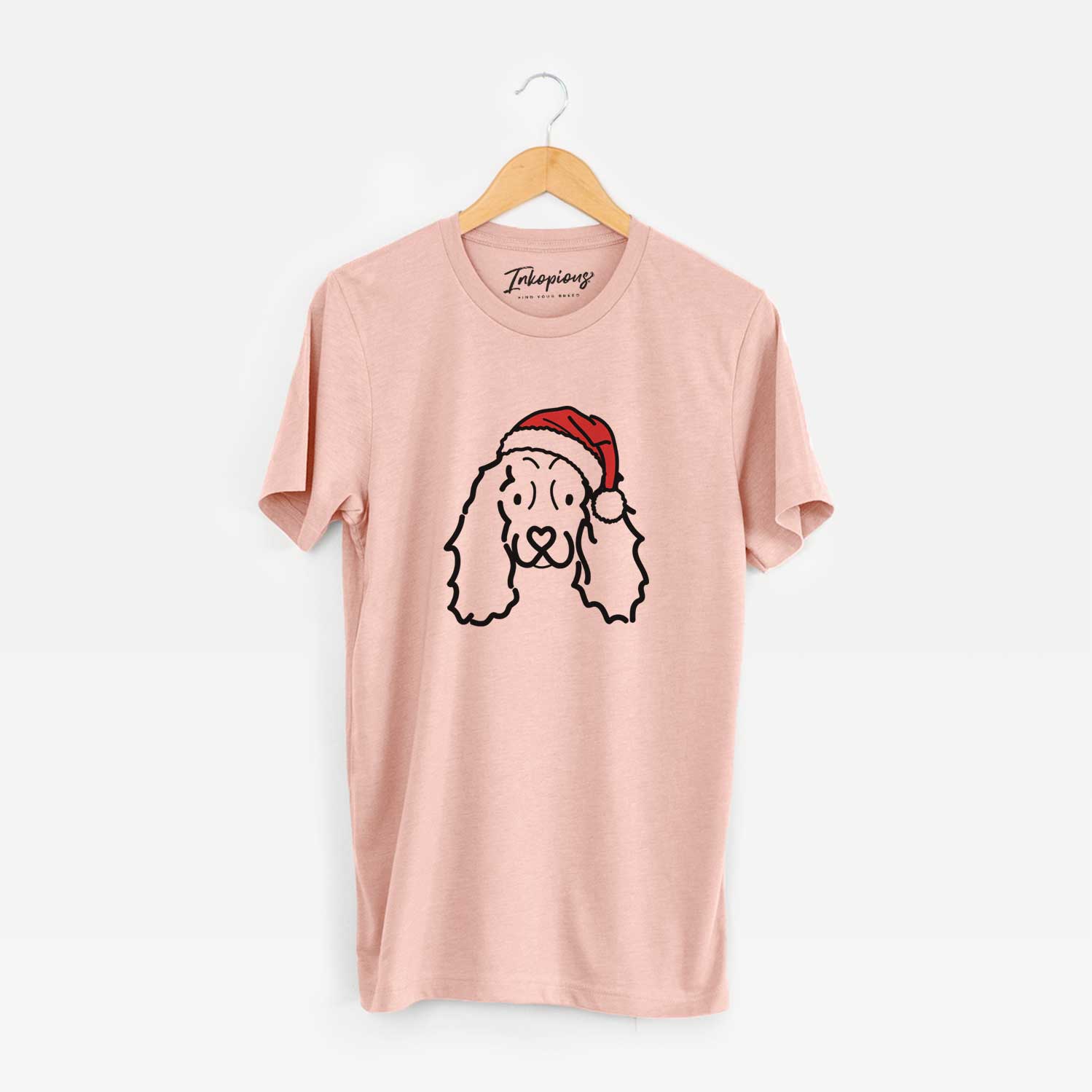 Minimalist line drawing of an American Cocker Spaniel wearing a Santa hat on a Peach Unisex crewneck