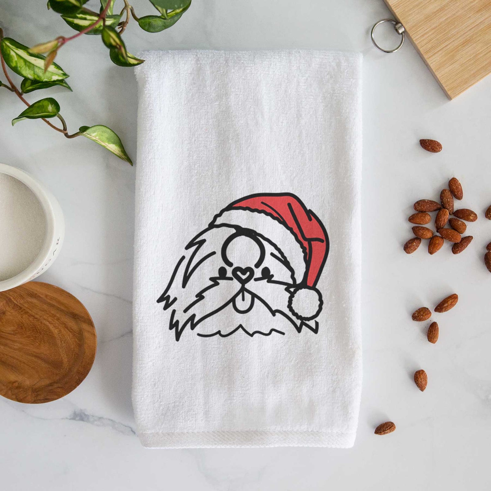 Minimalist line drawing of CoCo the Shih Tzu wearing a Santa hat on a decorative hand towel