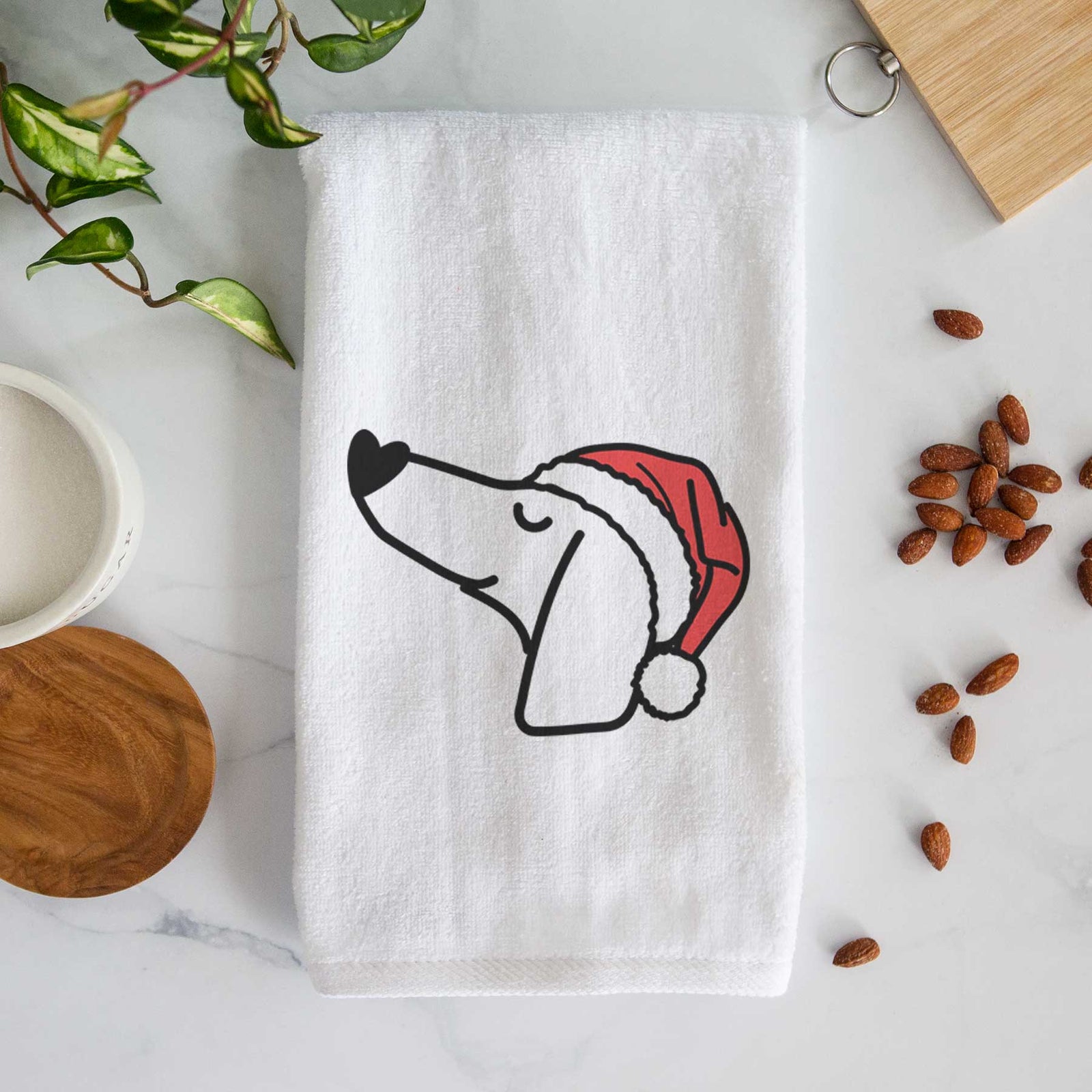 Minimalist line drawing of a Dachshund wearing a Santa hat on a decorative hand towel