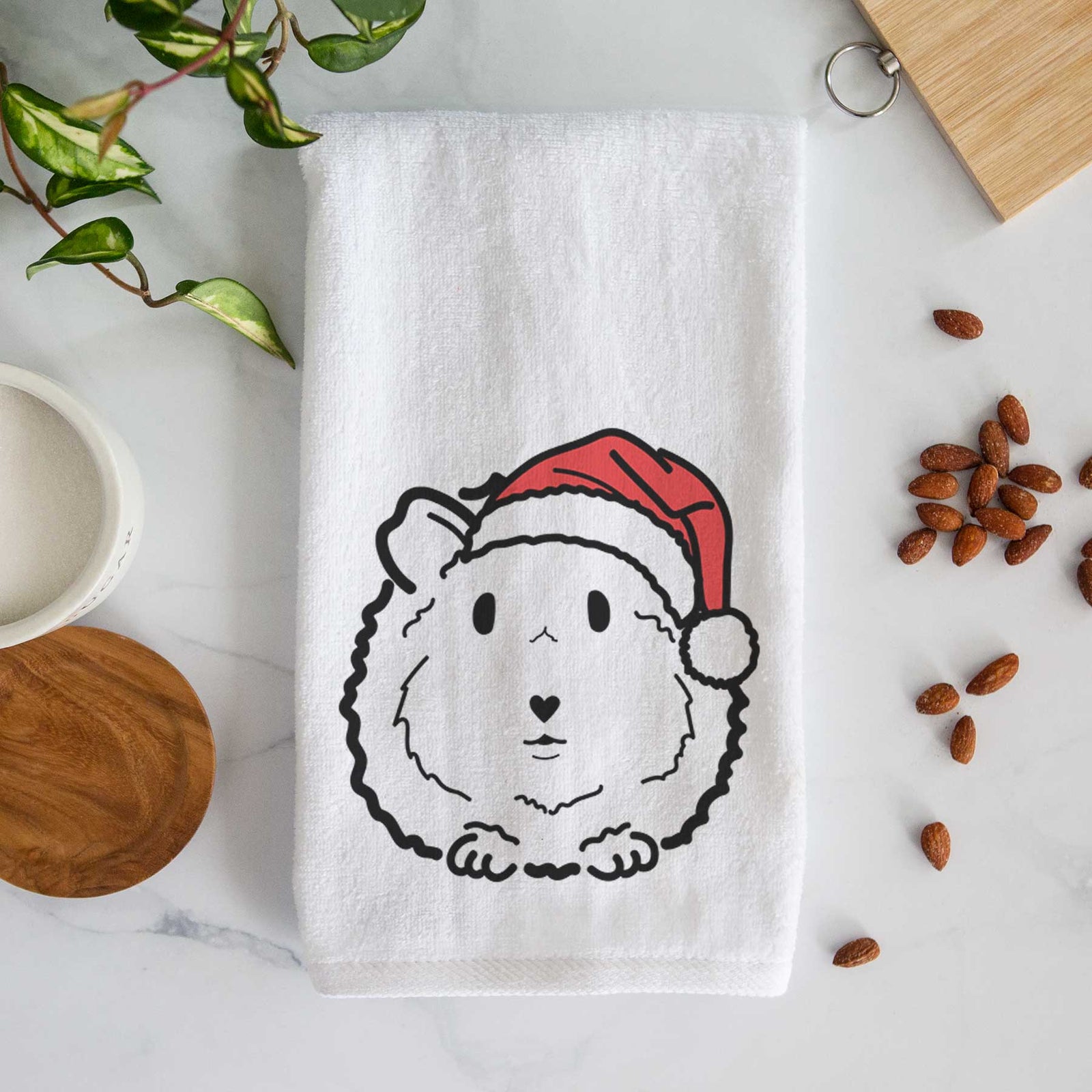 Minimalist line drawing of Duke the Guinea Pig wearing a Santa hat on a decorative hand towel