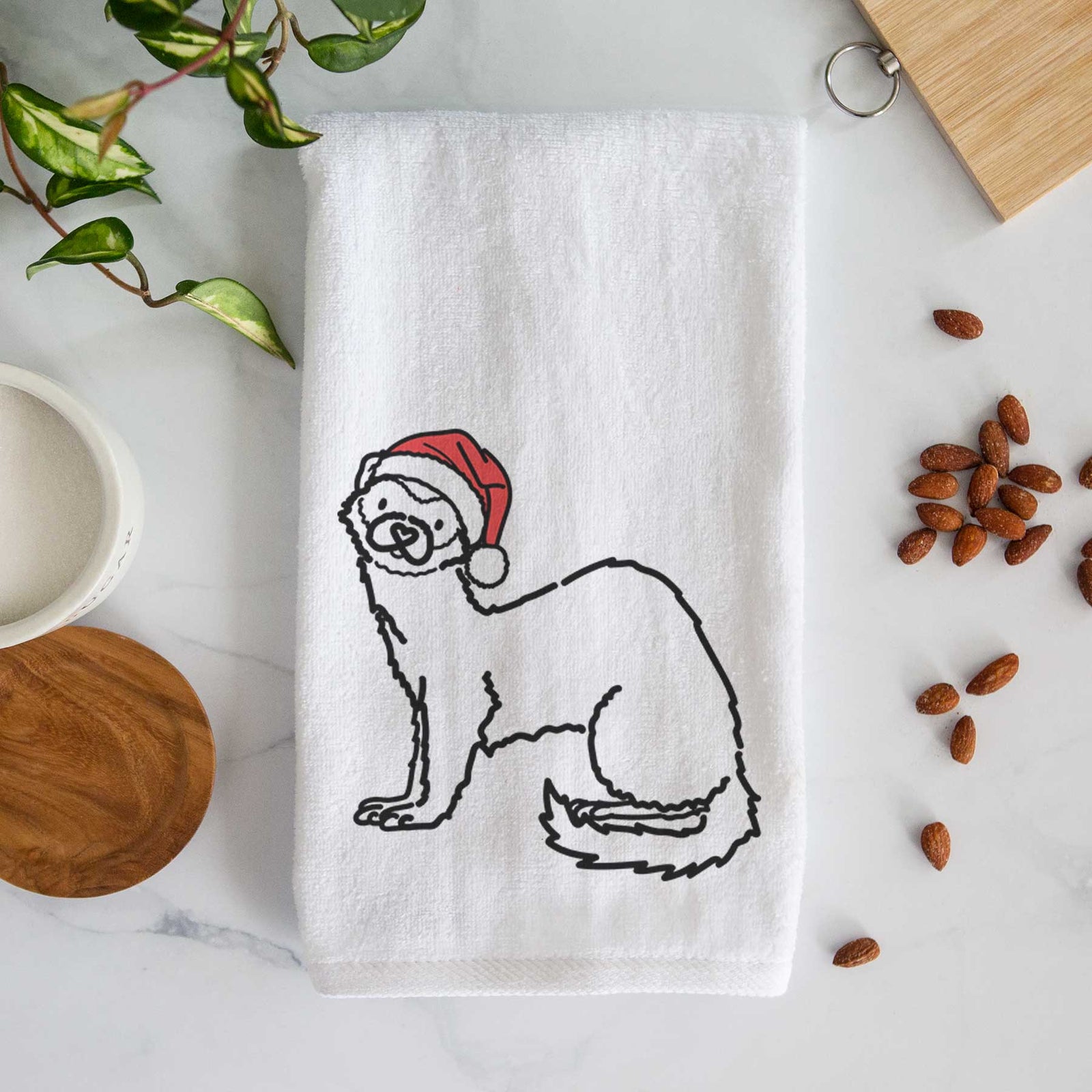 Minimalist line drawing of Fern the Ferret wearing a Santa hat on a decorative hand towel
