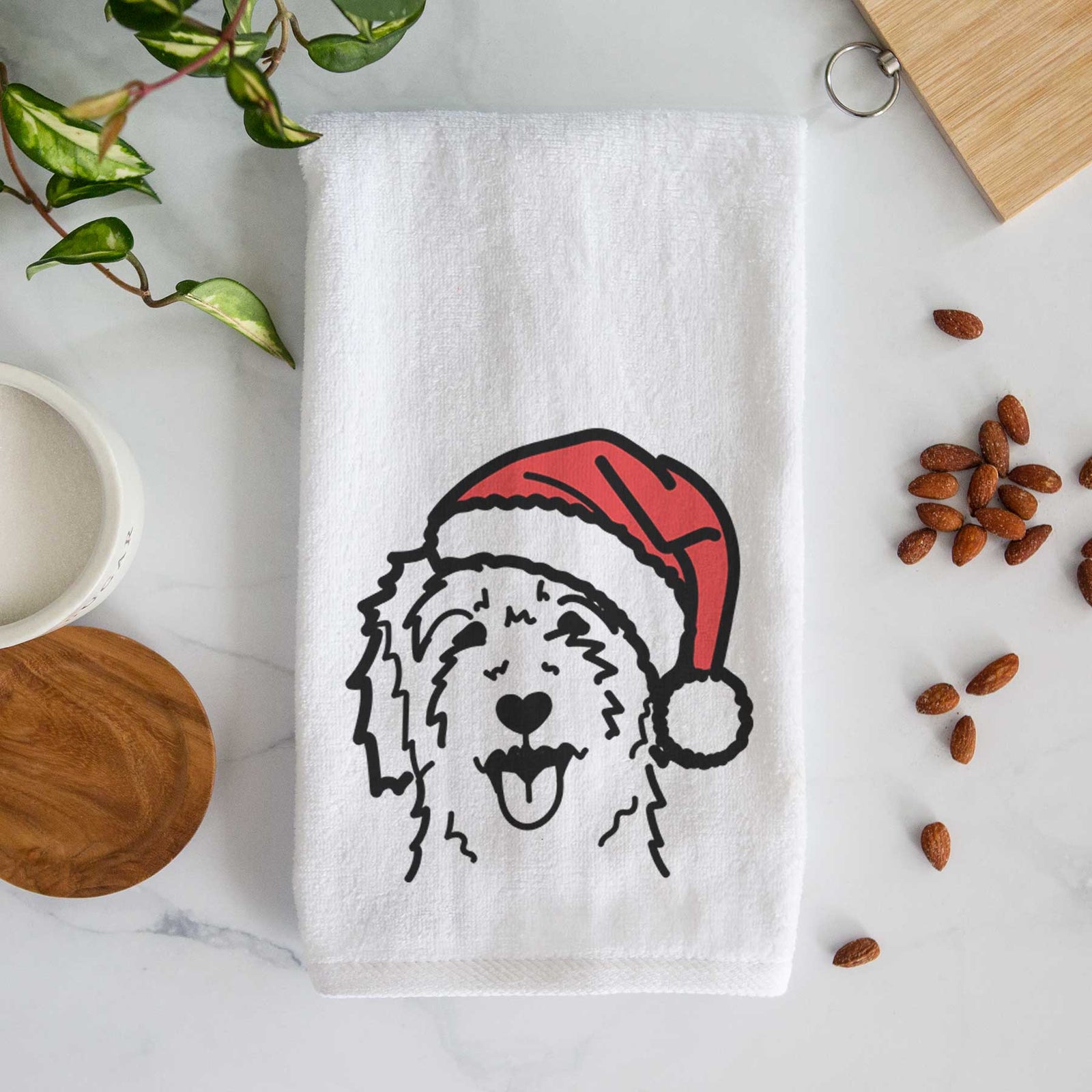 Minimalist line drawing of a Goldendoodle wearing a Santa hat on a decorative hand towel