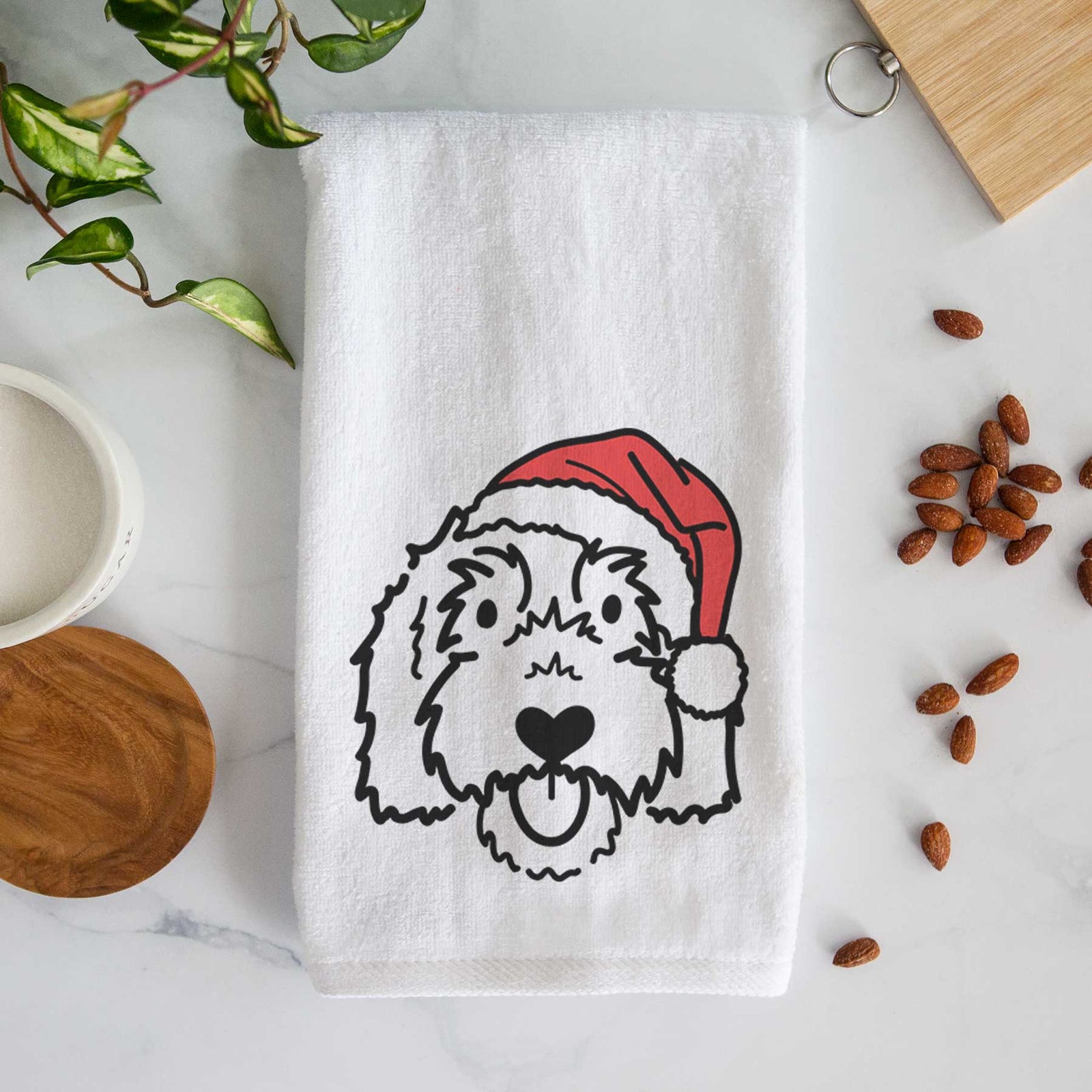 Minimalist line drawing of Gus the Goldendoodle wearing a Santa hat on a decorative hand towel
