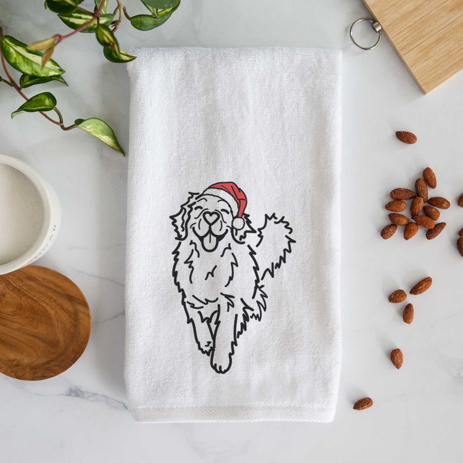 Minimalist line drawing of Hamlet the Golden Retriever wearing a Santa hat on a decorative hand towel