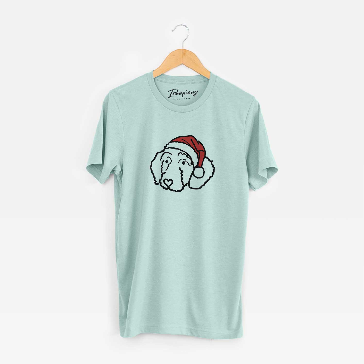 Minimalist line drawing of Hanna the Goldendoodle wearing a Santa hat on a Heather Sage Unisex crewneck