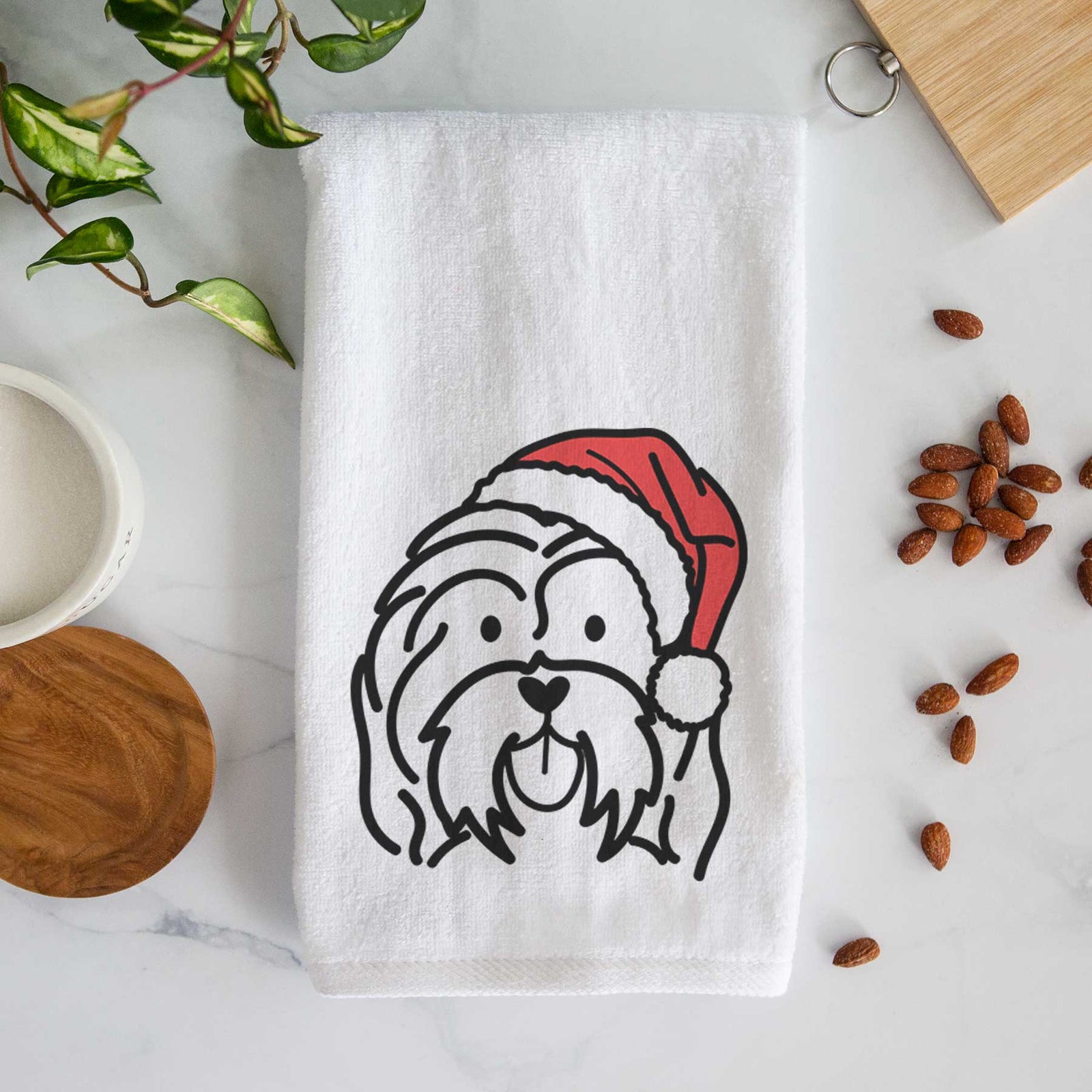 Minimalist line drawing of a Havanese wearing a Santa hat on a decorative hand towel