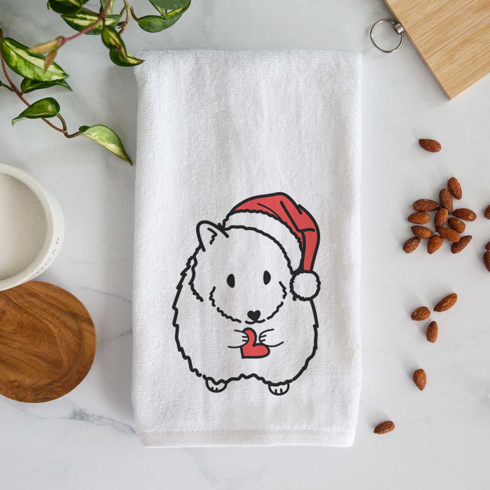 Minimalist line drawing of Hilga the Hamster wearing a Santa hat on a decorative hand towel