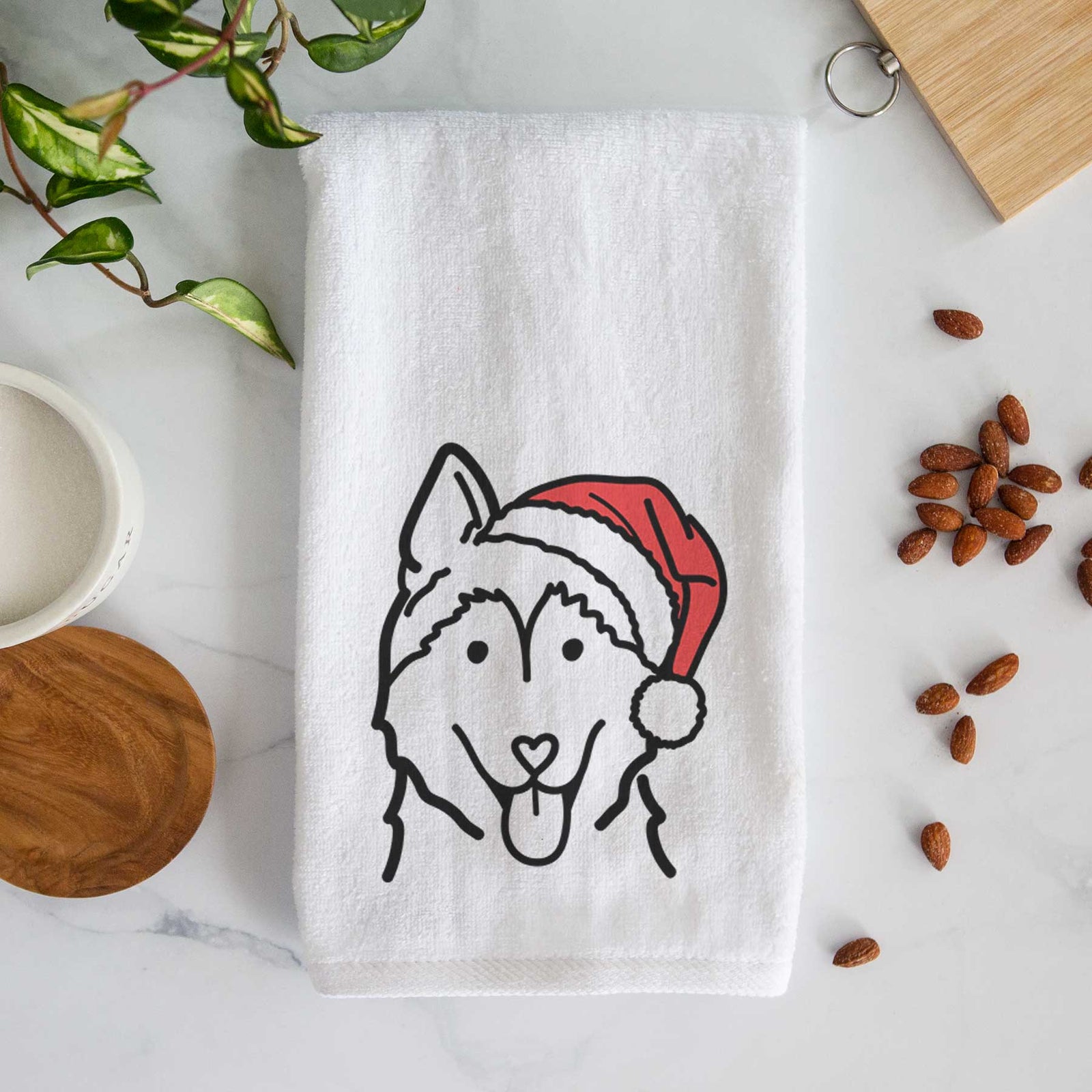 Minimalist line drawing of a Siberian Husky wearing a Santa hat on a decorative hand towel
